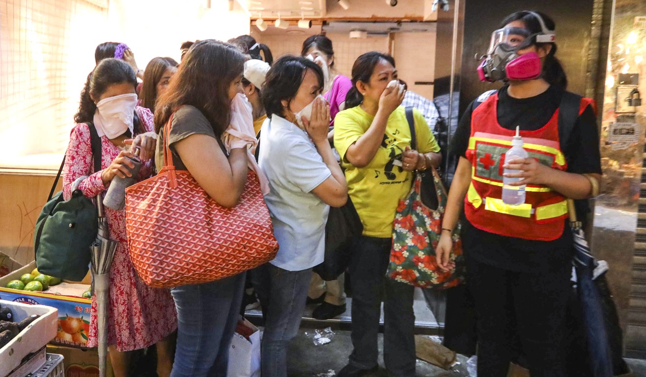 First-aid volunteers help women affected by tear gas. Photo: Felix Wong