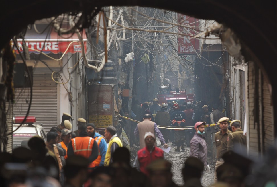 A fire engine stands by the site of a fire in an alleyway. Photo: AP