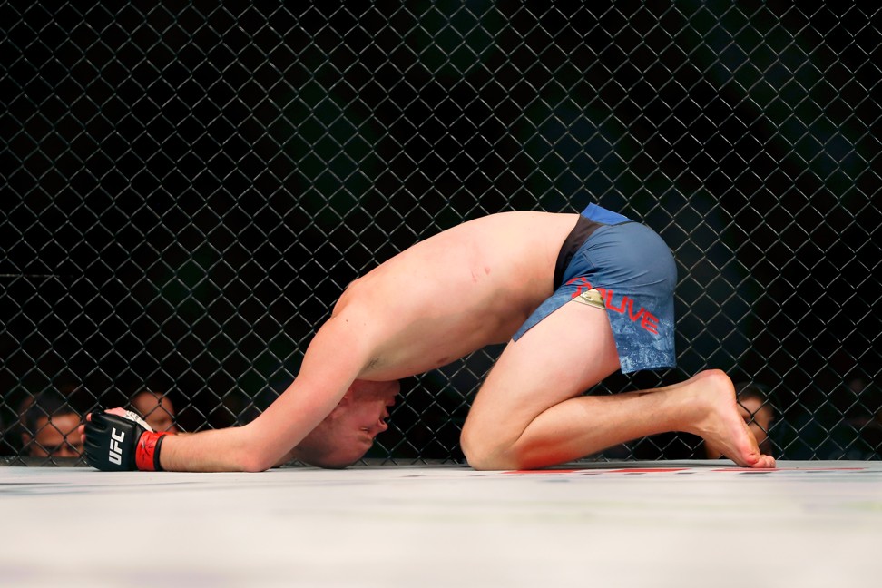Stefan Struve tries to recover after taking a low kick by Ben Rothwell.
