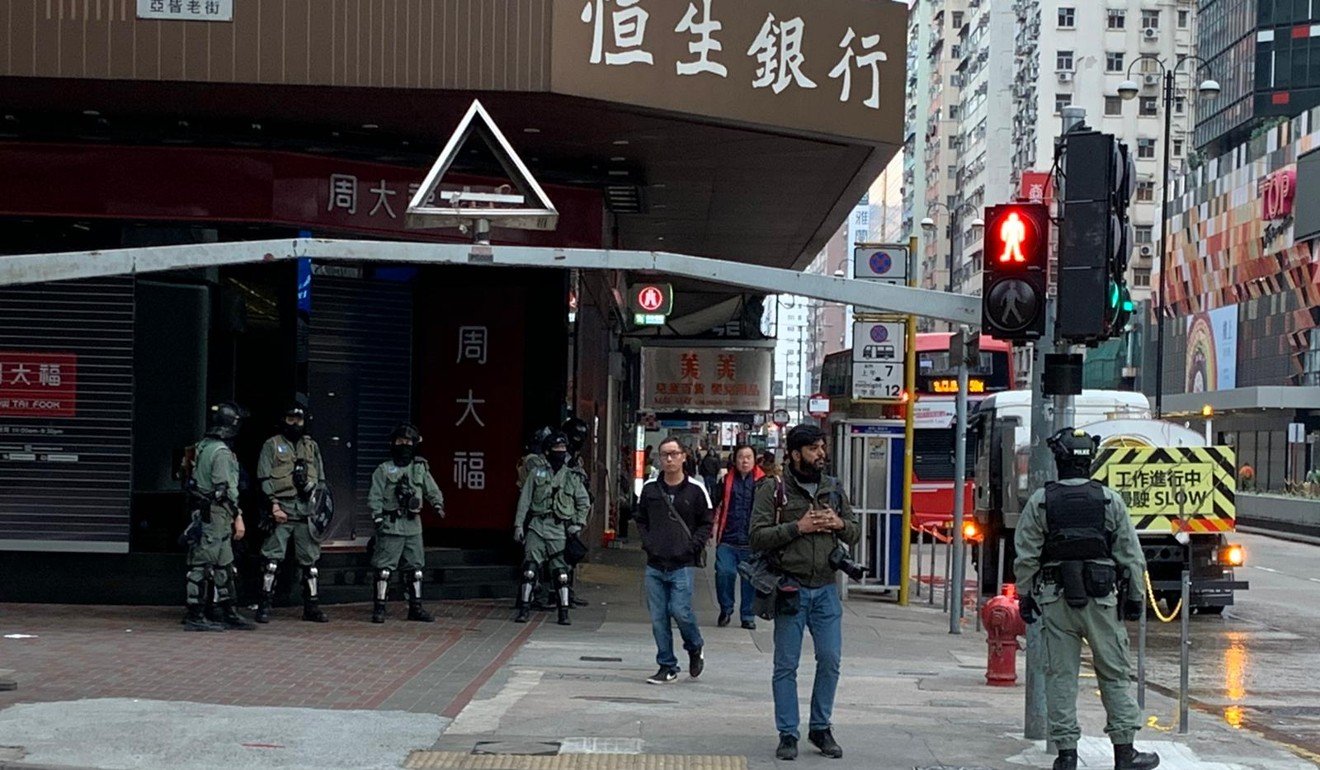 Riot police wait on a street corner in Mong Kok. Photo: Victor Ting