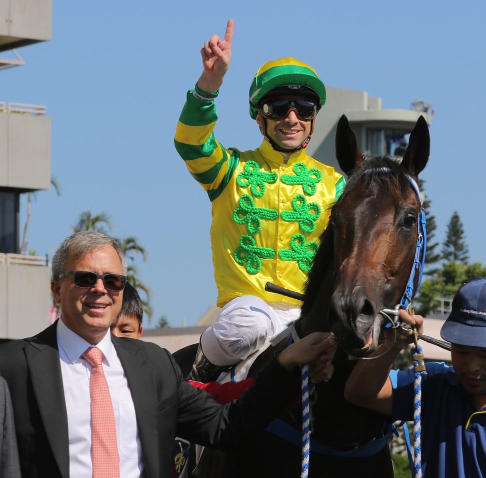 Umberto Rispoli celebrates the win of Sky Darci with trainer Caspar Fownes at Sha Tin this season.