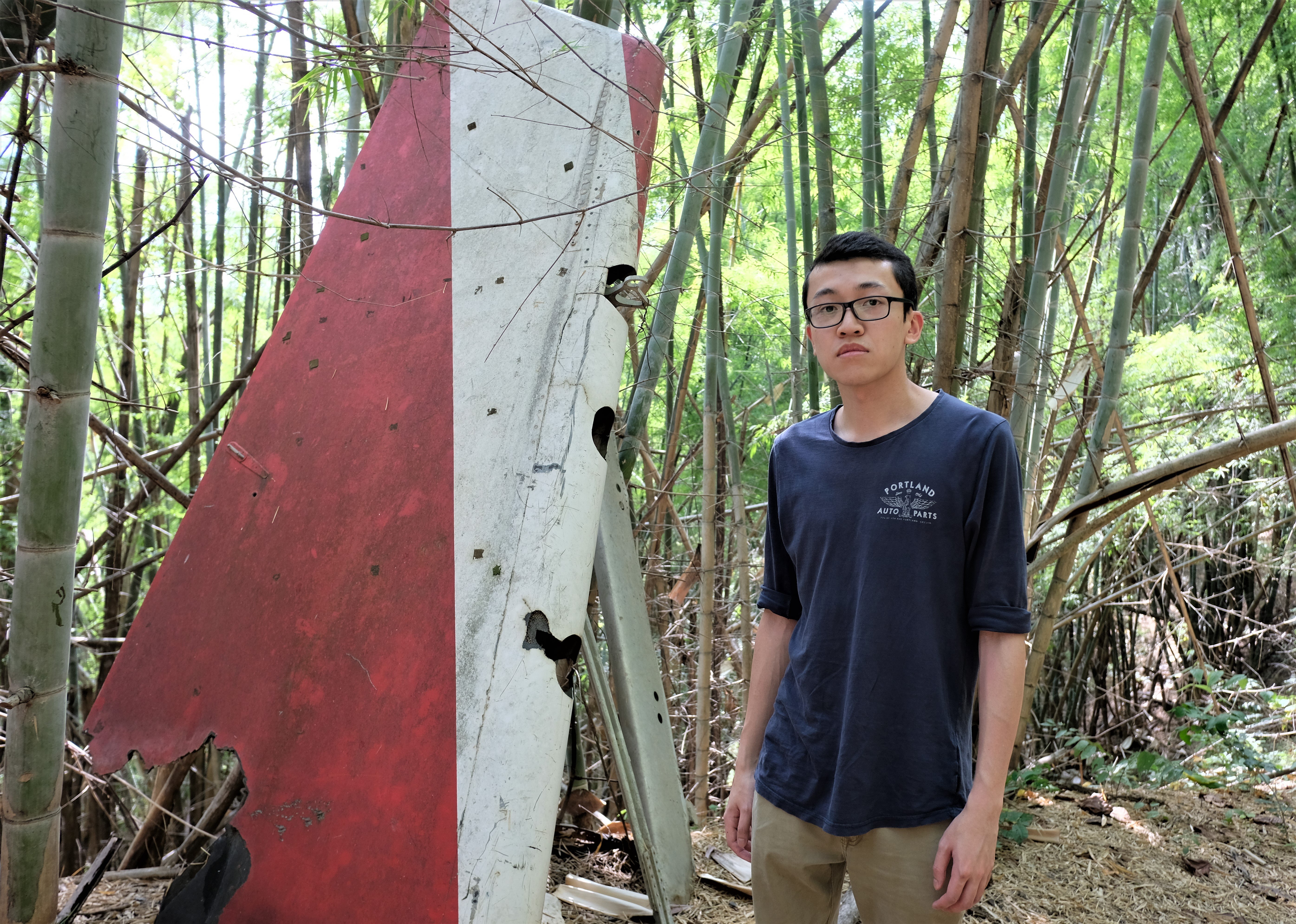 Felix Wong, a Hong Kong-born Canadian, in a jungle in Suphanburi, Thailand, beside a vertical stabiliser that belonged to the Lauda Air Flight 004 plane that crashed on its way from Hong Kong to Vienna in 1991. His aunt was among the 223 people killed. Photo: Tibor Krausz