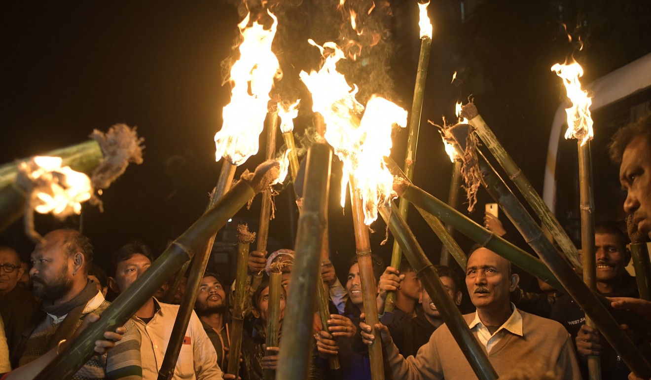 Protesters take part in a torchlight procession against the Citizenship Amendment Bill in Guwahati, Assam, on Monday. Photo: EPA-EFE