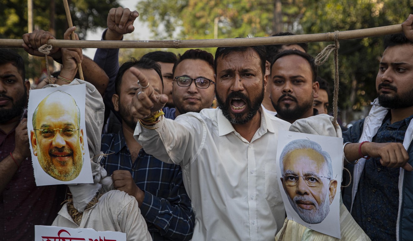 Activists hang the effigies of Indian PM Narendra Modi and Home Minister Amit Shah during a protest against the Citizenship Amendment Bill in Gauhati on Monday. Photo: AP
