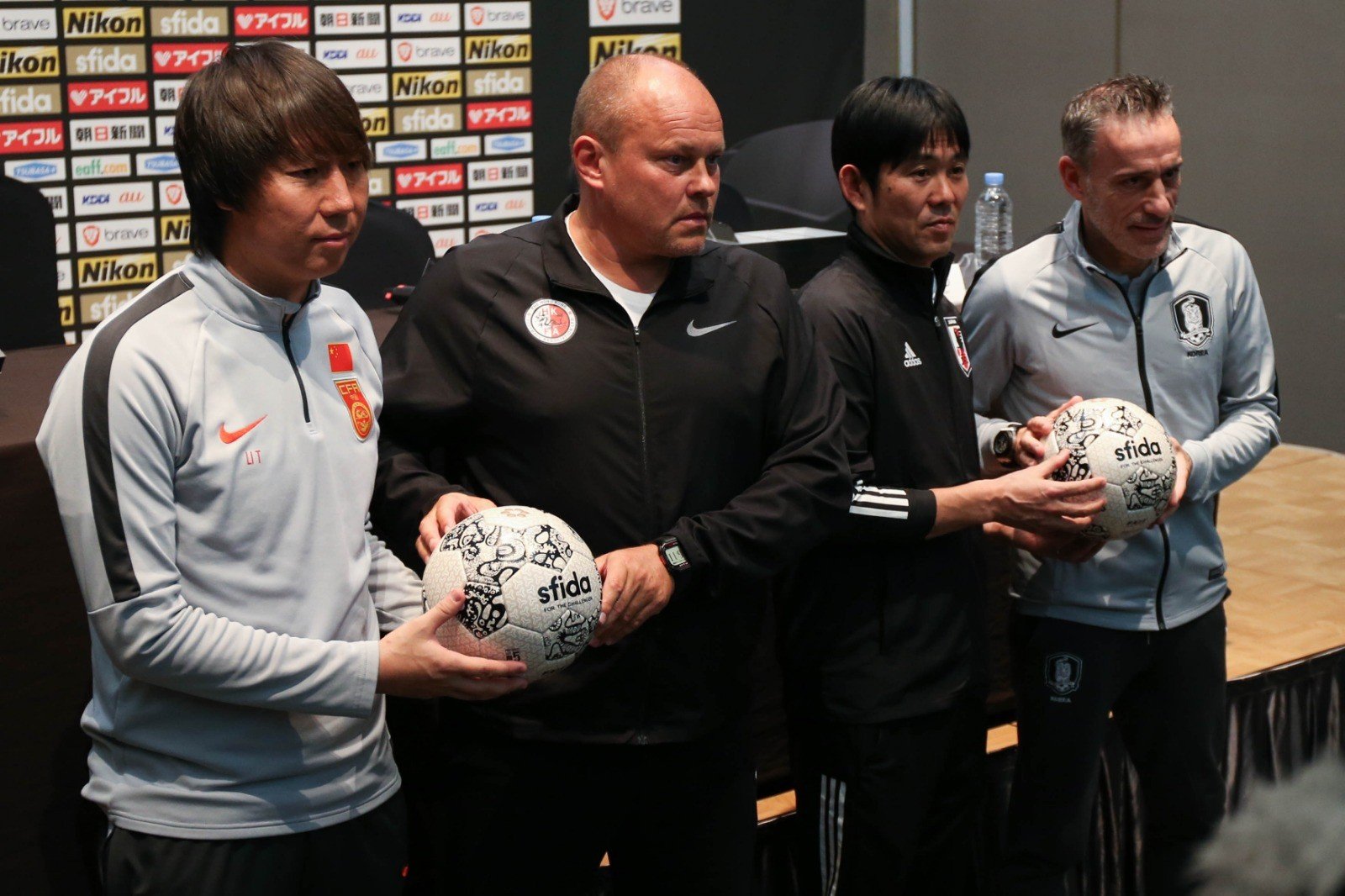 China coach Li Tie, Hong Kong coach Mixu Paatelainen, Japan coach Hajime Moriyasu and South Korea coach Paulo Bento (from left to right) pose at the EAFF 2019 press conference in Busan. Photo: HKFA