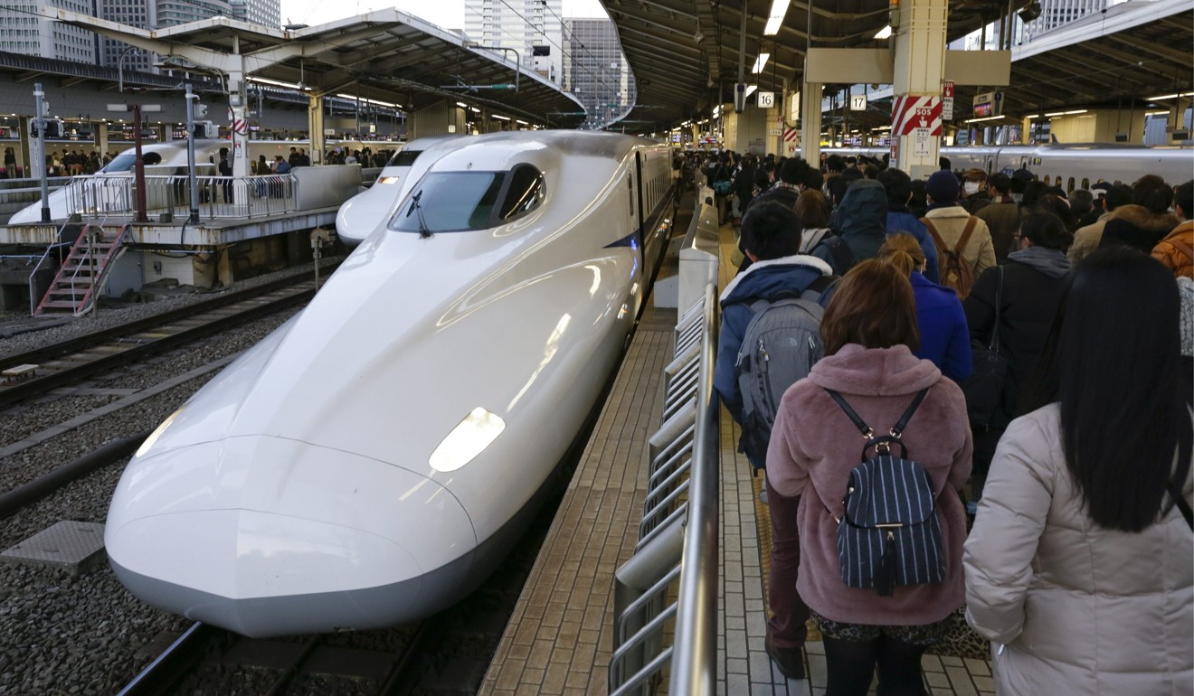 Travellers wait to get on a Shinkansen train at the Tokyo railway station on December 30, 2016, ahead of the New Year holiday break. Japan, a pioneer in the development of bullet trains, made the right choice during its economic take-off to focus on high-speed rail technology. Photo: EPA