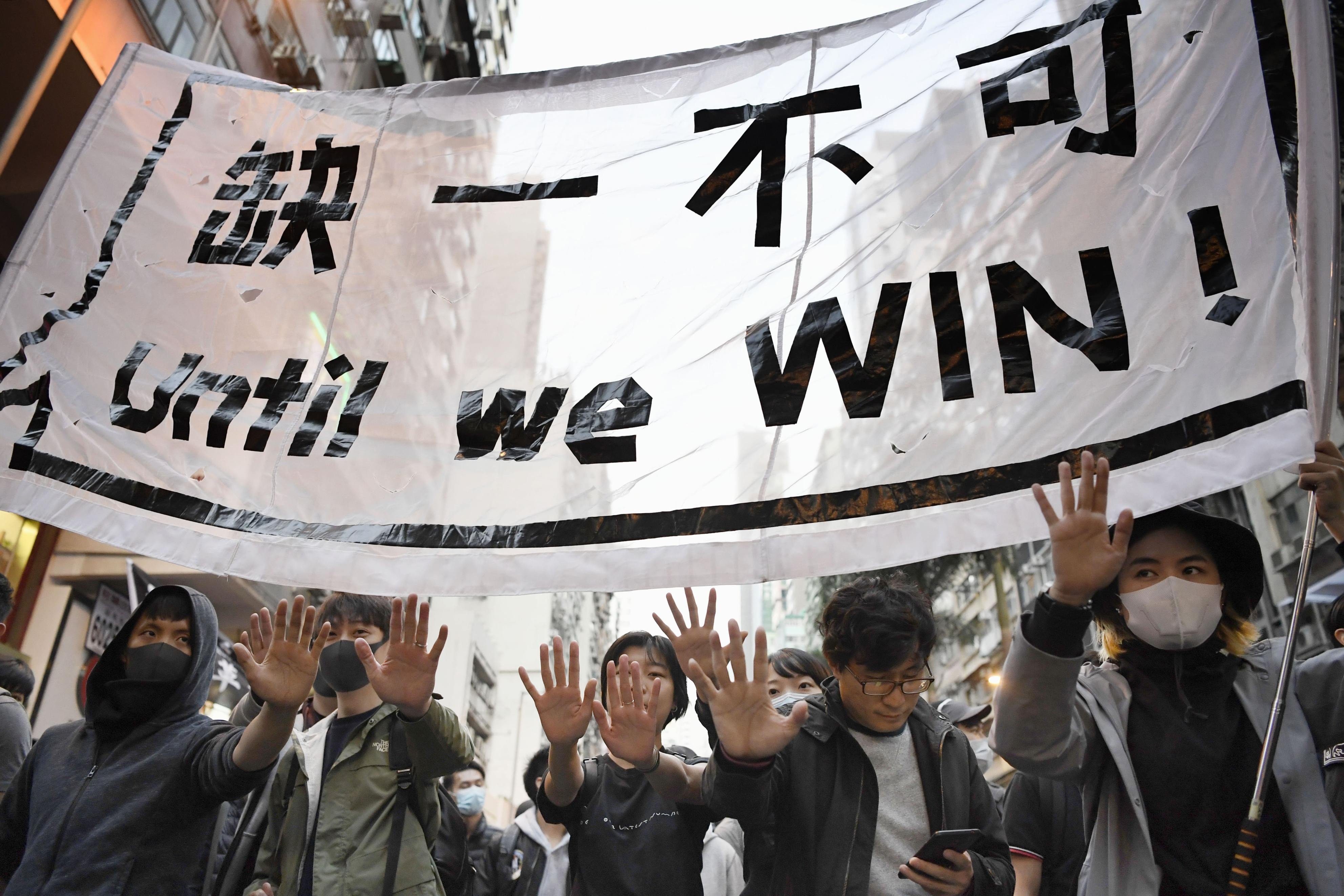 Protesters call for their five demands to be met during the anti-government rally in Hong Kong on December 8. Photo: Kyodo