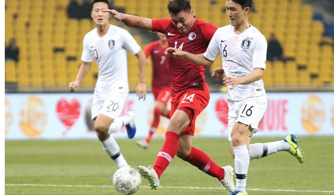 Hong Kong’s James Ha (centre) tries to outpace his marker. Photo: HKFA