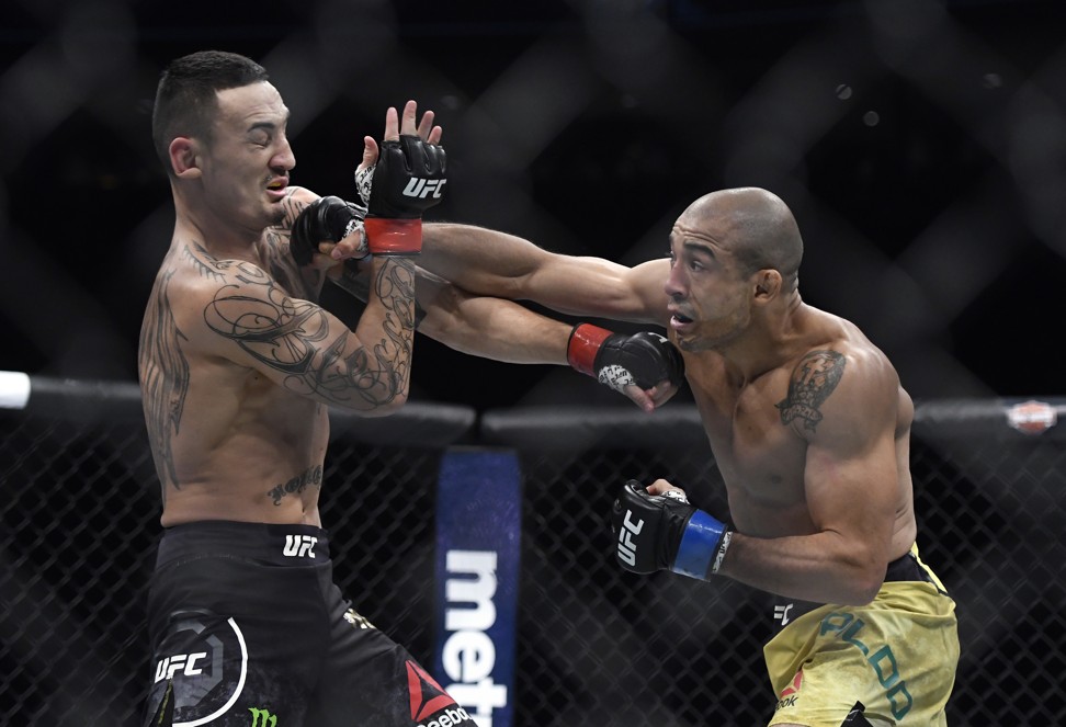 Max Holloway is hit by Jose Aldo at UFC 218. Photo: AP