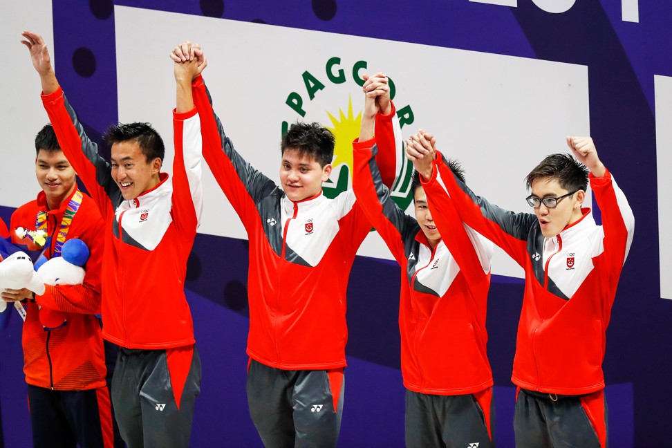 Singapore swim team members (from left) Quah Zheng Wen, Joseph Schooling, Jonathan Tan, and Yi Shou Darren Chua celebrate on the podium after winning the gold medal at the Southeast Asian Games. Photo: EPA