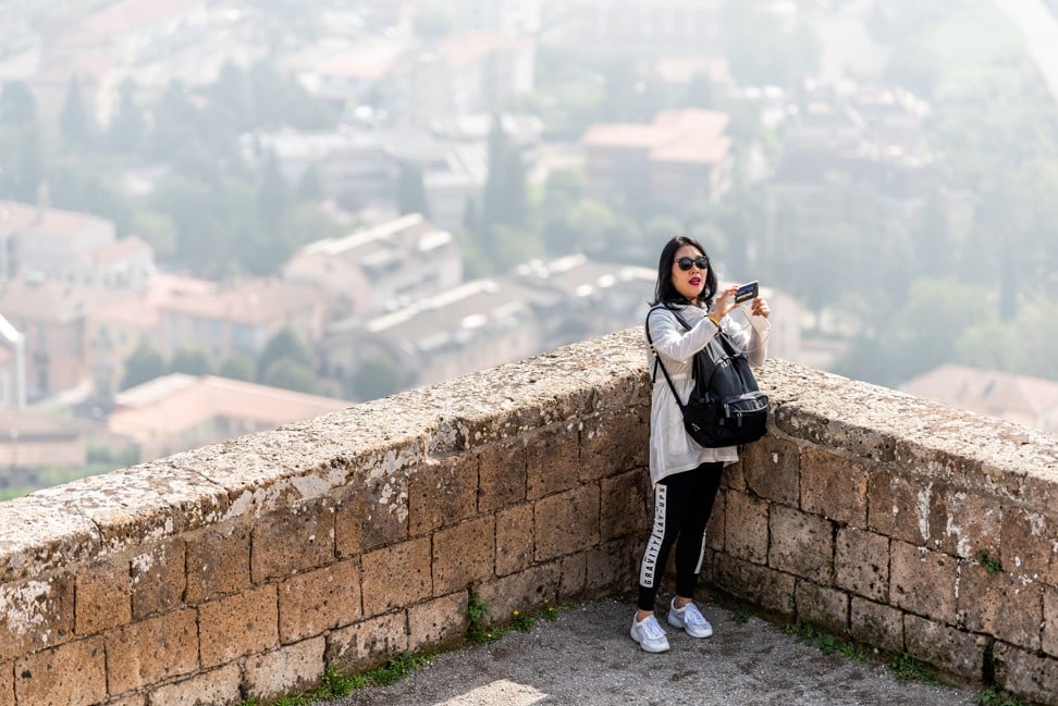A Chinese tourist poses for a selfie in rural Italy. Photo: Shutterstock