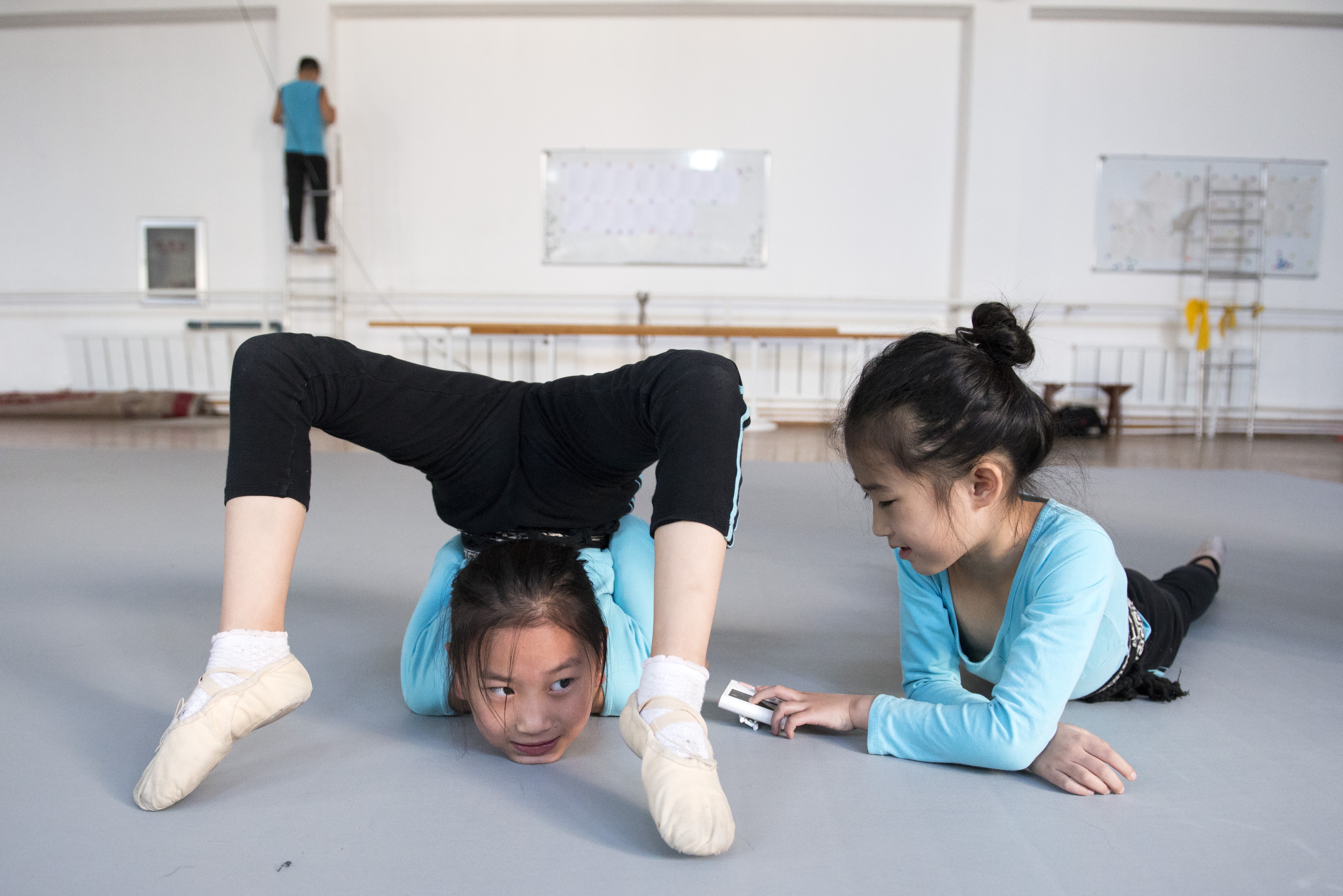 Students practise at Shenyang Acrobatic Troupe School, in China. Photo: Zigor Aldama