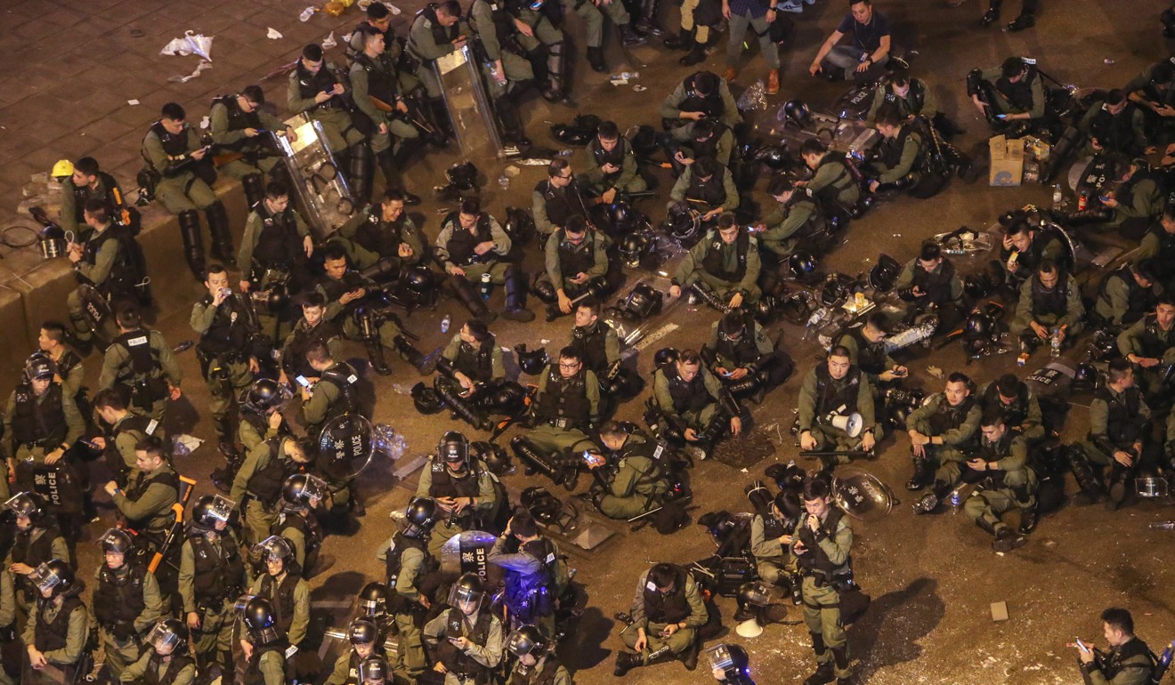 Riot police take a break on the streets of Sheung Wan. Photo: Winson Wong