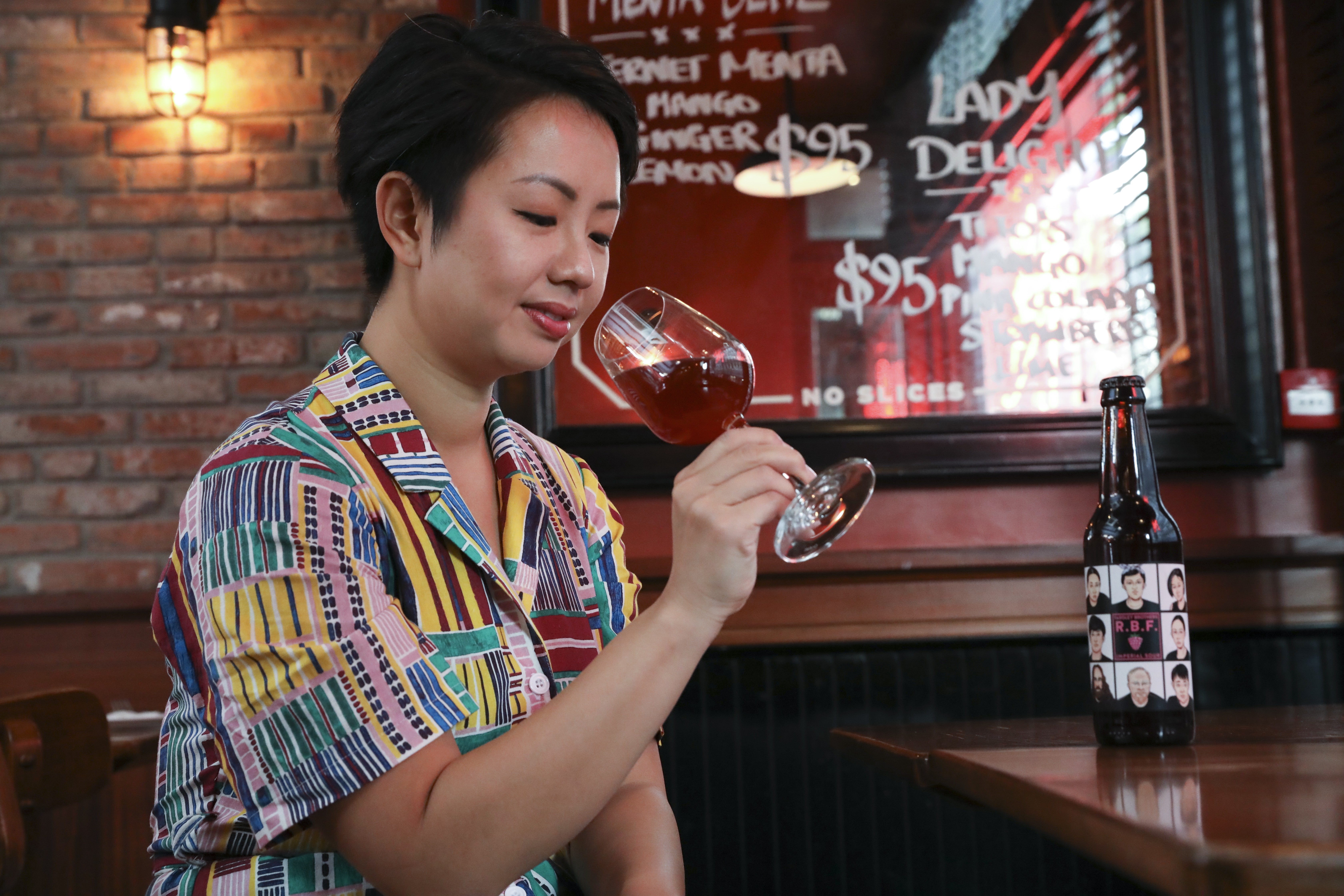 Stella Lo of the Pink Boots Society, an all-female brewing collective, samples its latest beer, called Resting Bitch Face, at Alvy’s restaurant in Kennedy Town, Hong Kong. Photo: K.Y. Cheng