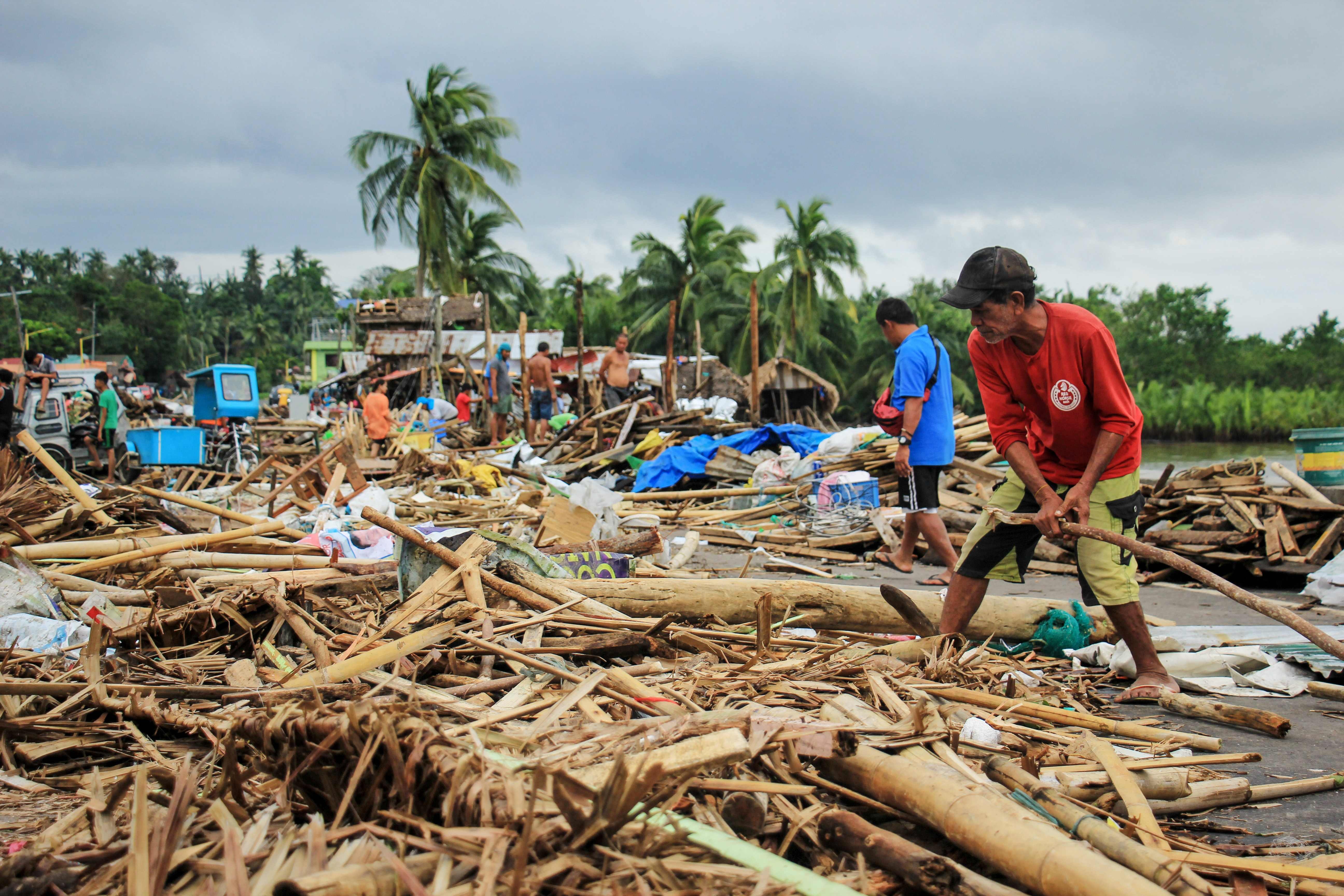 Residents of Sorsogon, south of Manila, gather debris following a typhoon. Photo: AFP