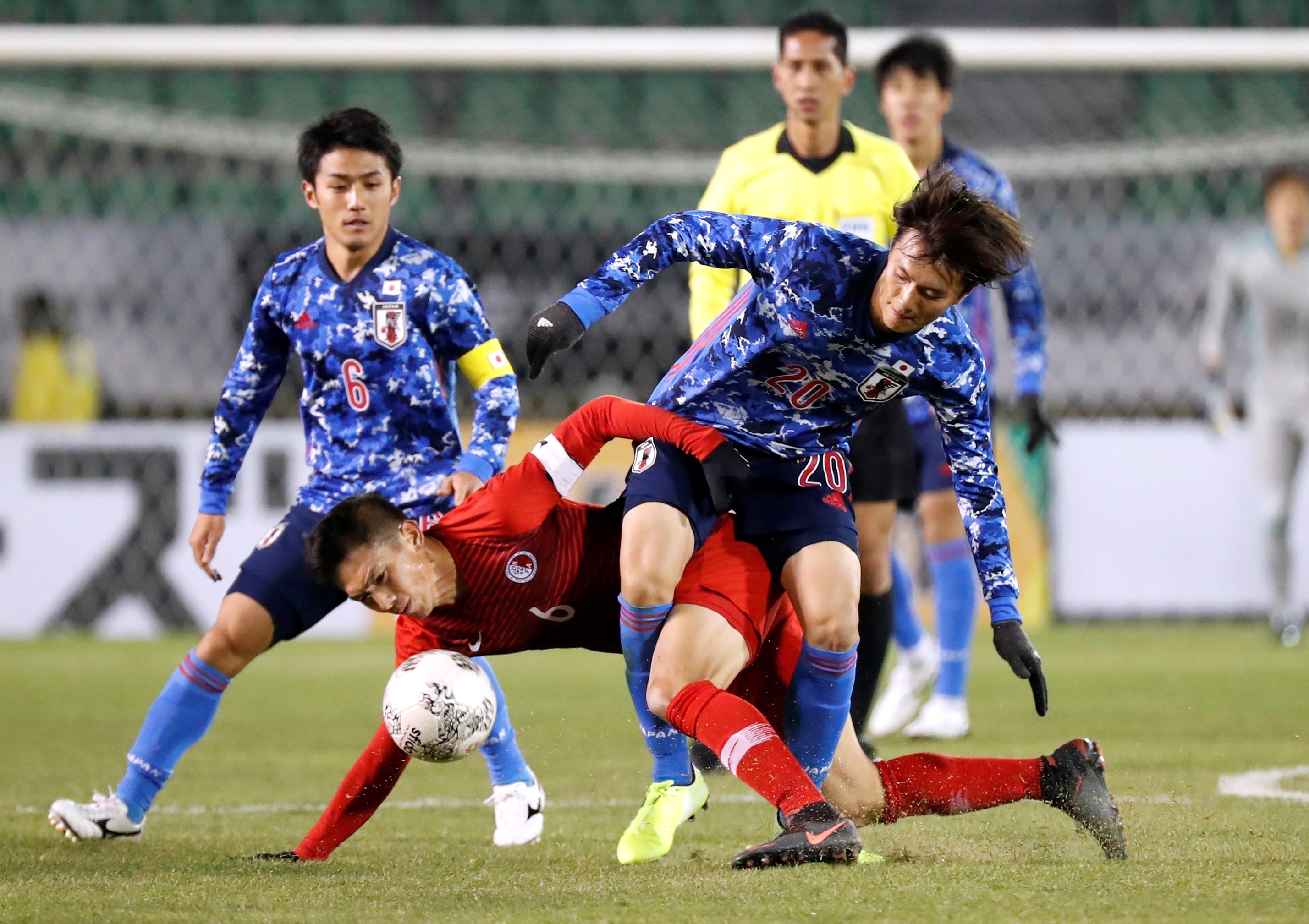Japan's Koki Ogawa (right) gets into a tangle with Hong Kong captain Huang Yang during their EAFF Championship game. Photo: Reuters