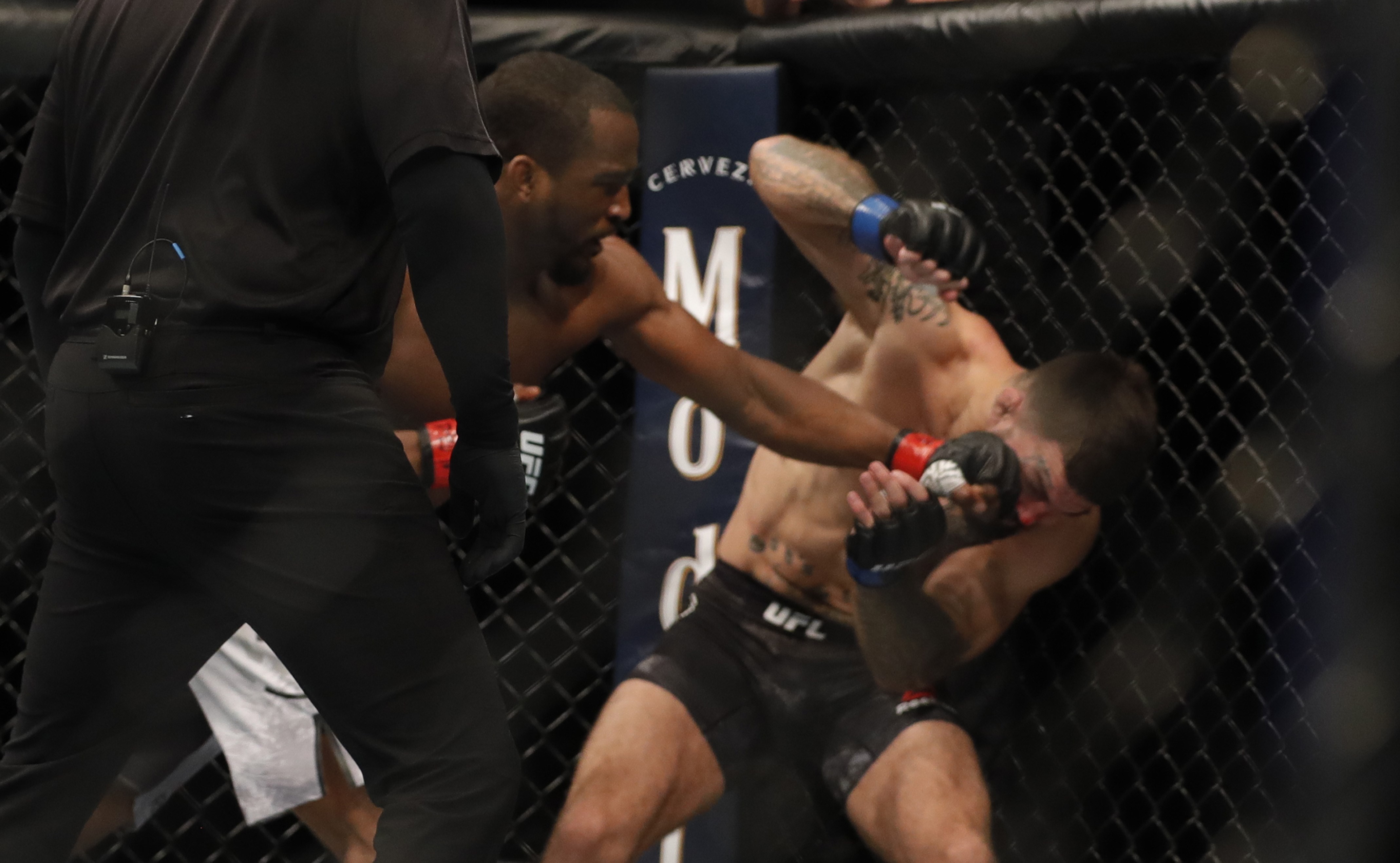 Geoff Neal lands a punch that sends Mike Perry to the canvas at UFC 245. Photo: AFP