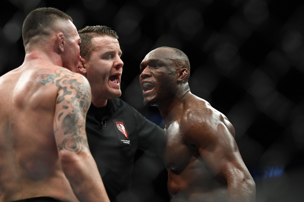 Kamaru Usman and Colby Covington are separated by referee Marc Goddard. Photo: USA TODAY Sports