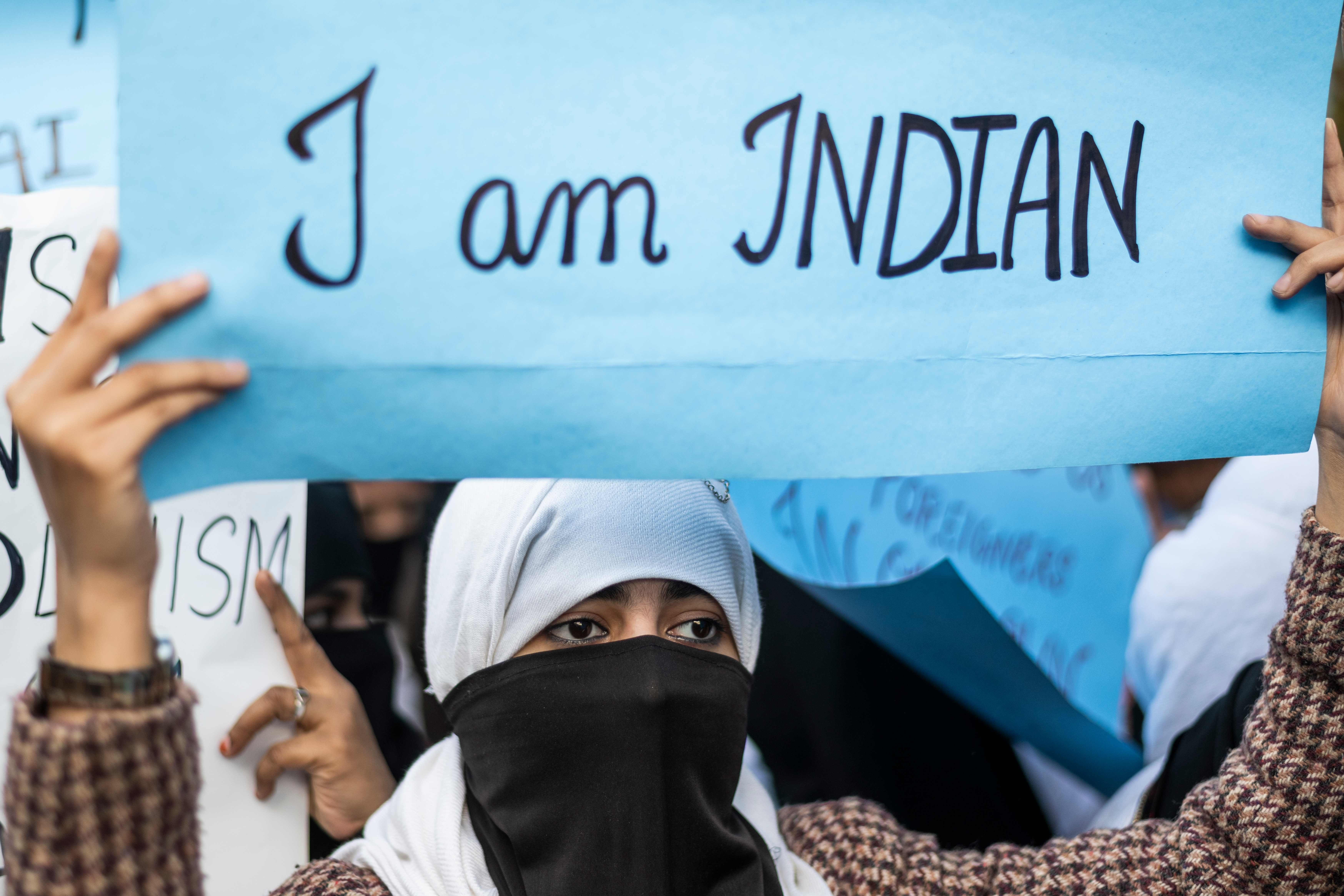 A woman holds up a placard during a protest against the Indian government’s Citizenship (Amendment) Bill in New Delhi on December 14. Photo: AFP