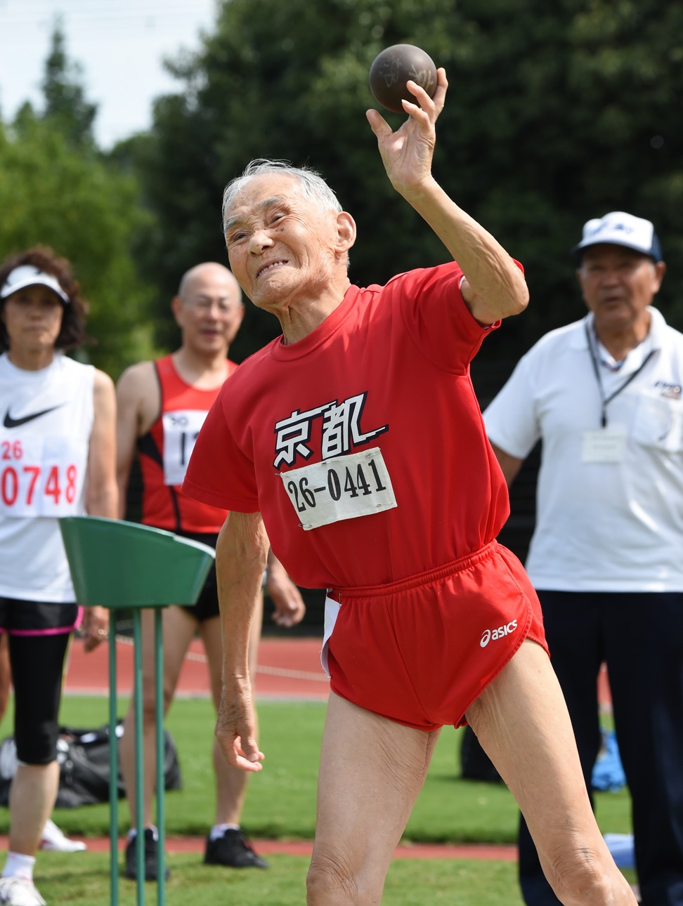Hidekichi Miyazaki, 105, throws a shot put after running with other competitors all over 80 years of age in a 100m sprint in the Kyoto Masters in Kyoto, western Japan. Photo: AFP