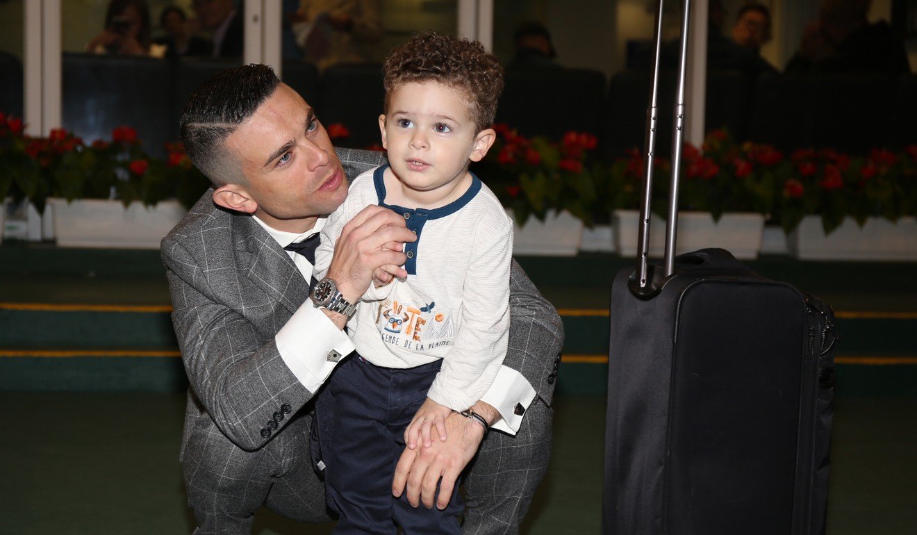 Jockey Umberto Rispoli with his son Hayden after his final ride in Hong Kong.