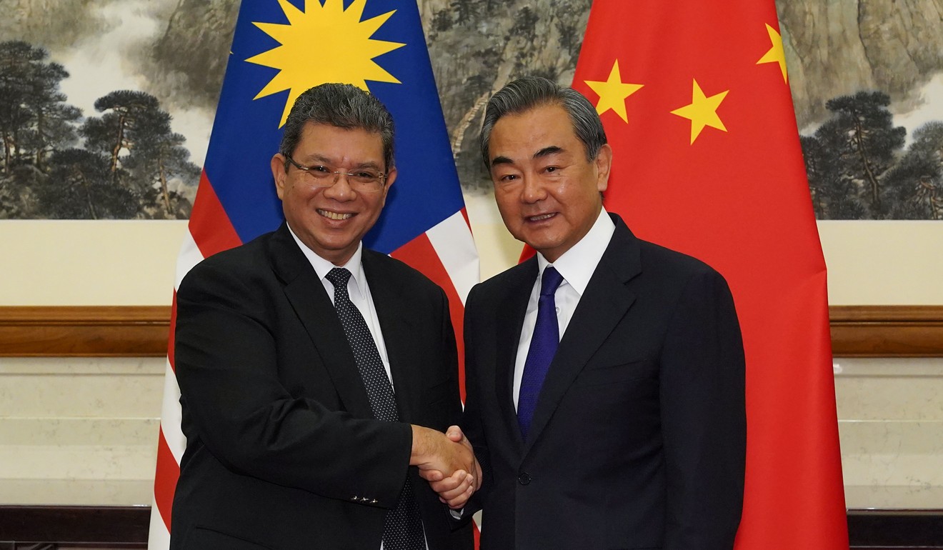 Chinese Foreign Minister Wang Yi (right) meets his Malaysian counterpart Saifuddin Abdullah in September. The two sides agreed to set up a new dialogue mechanism on South China Sea issues. Photo: Reuters