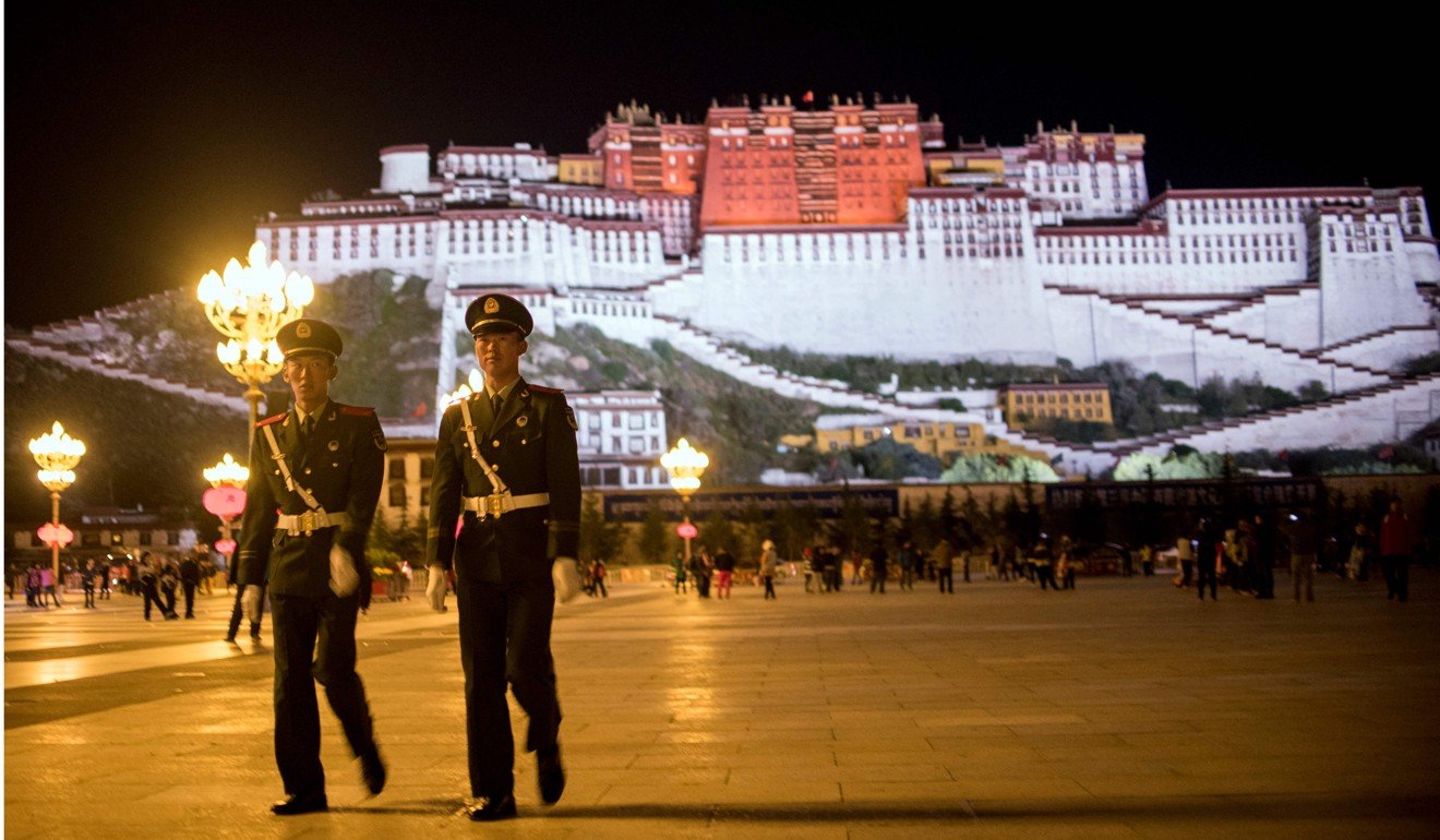 Paramilitary police patrol near the Potala Palace in Lhasa, Tibet. Months after Chen Quanguo was named party chief of the region, it advertised for another 2,500 police. Photo: AFP