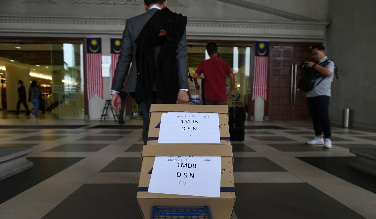 Documents pertaining to the trial of Malaysia’s former prime minister Najib Razak are taken to the high court. Photo: AFP