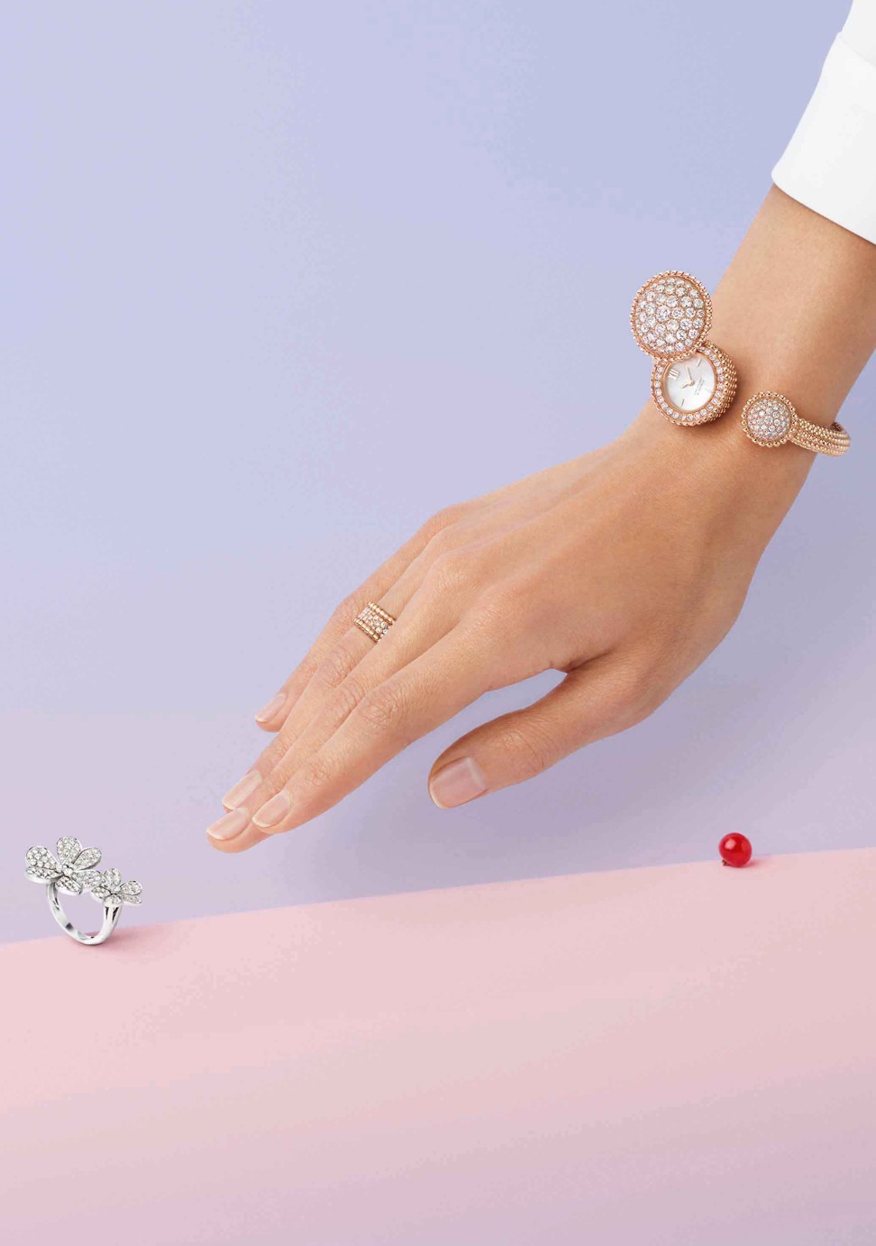 Perlée rose gold watch with white mother-of-pearl, diamonds; Perlée diamond ring with three rows of rose gold and diamonds; and a Frivole Between the Finger Ring with white gold and diamonds from the Diamond Breeze Collection. Photo: Van Cleef & Arpels