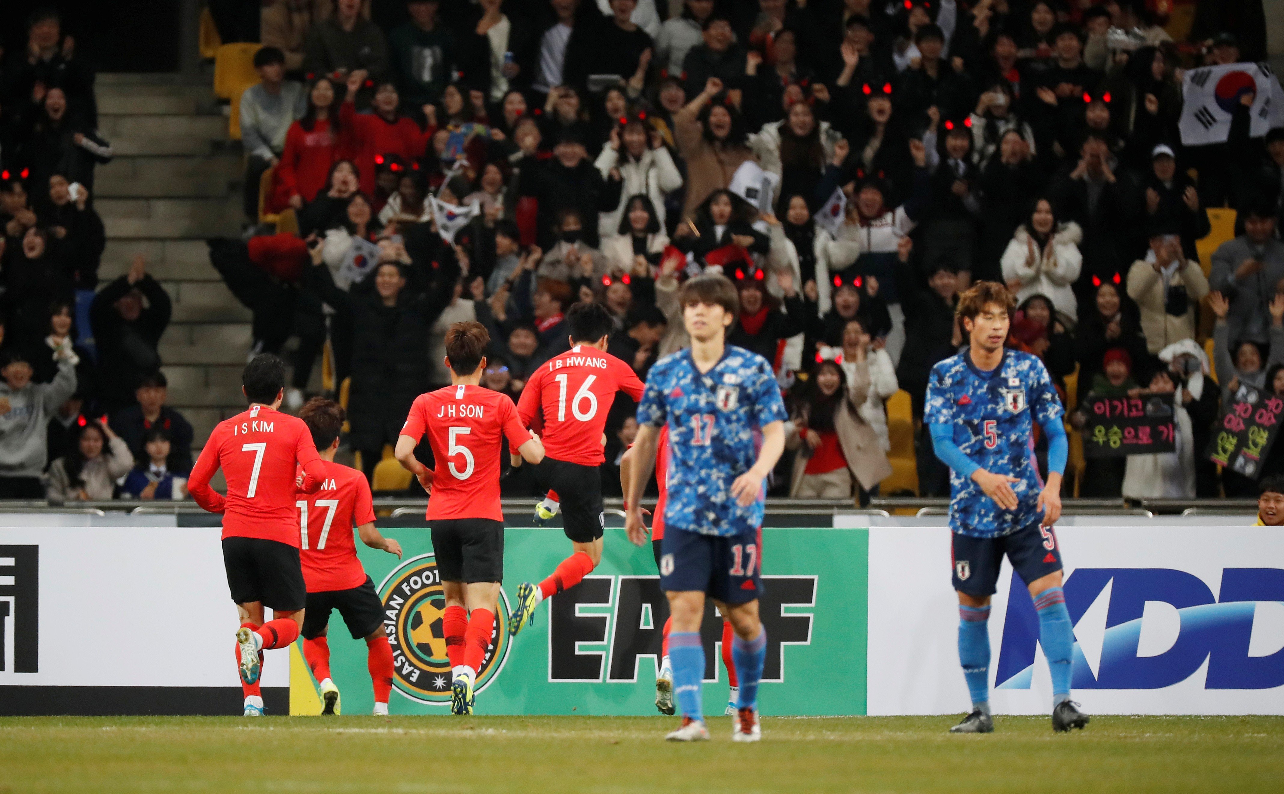 South Korea’s Hwang In-Beom celebrates scoring with teammates as Japan’s players walk away. Photo: Reuters