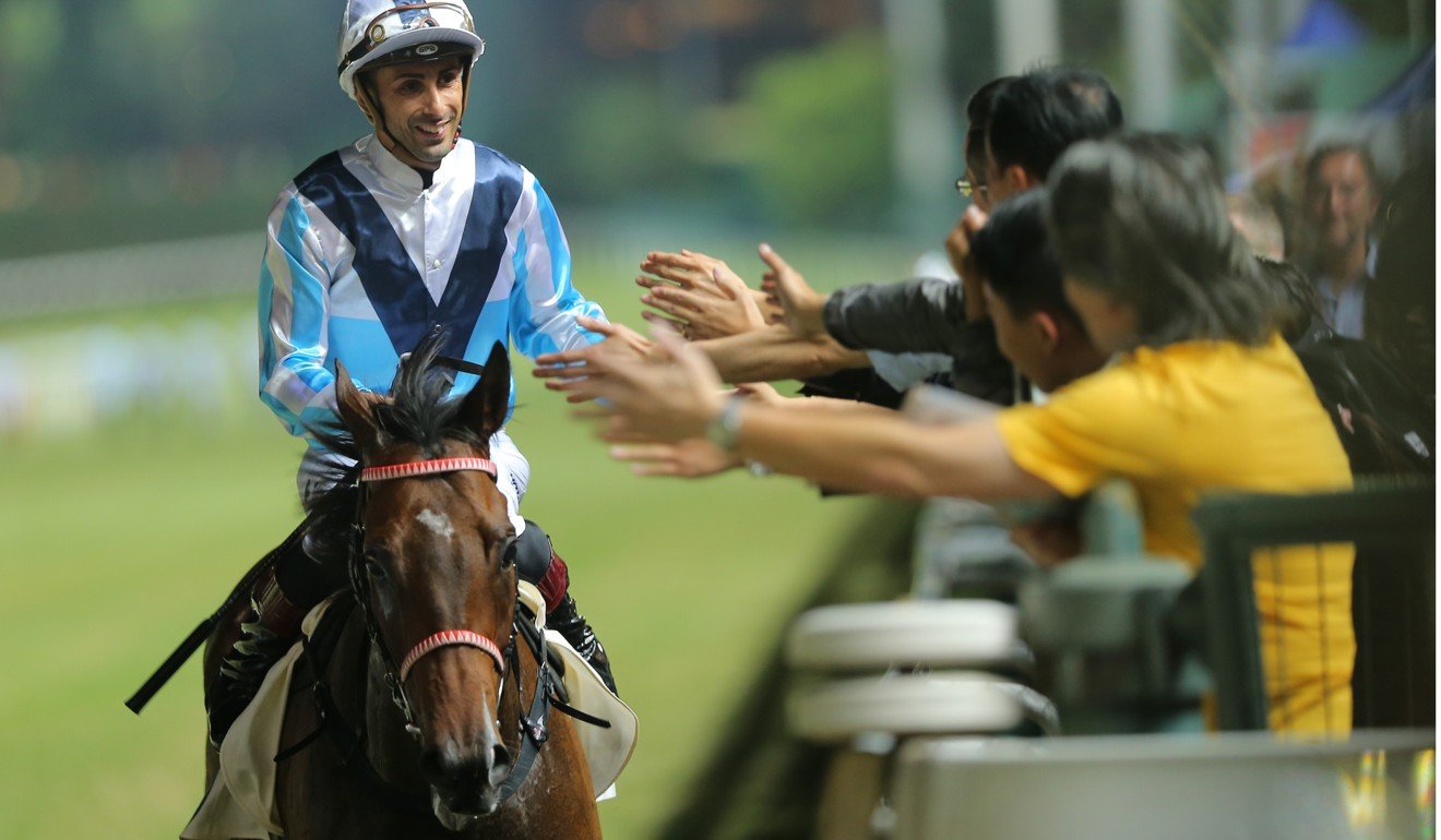 Alberto Sanna celebrates a win with fans at Happy Valley.