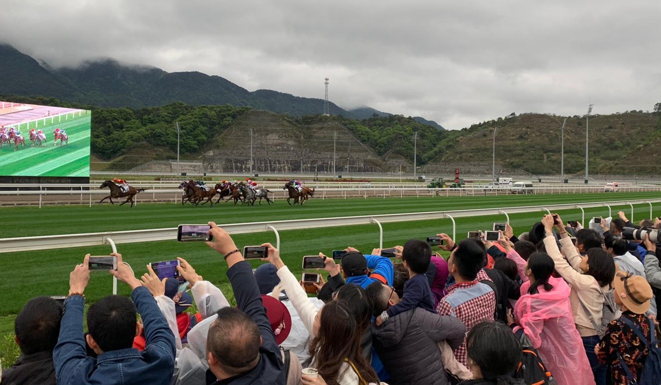 Fans capture the action at the first official meeting at Conghua.