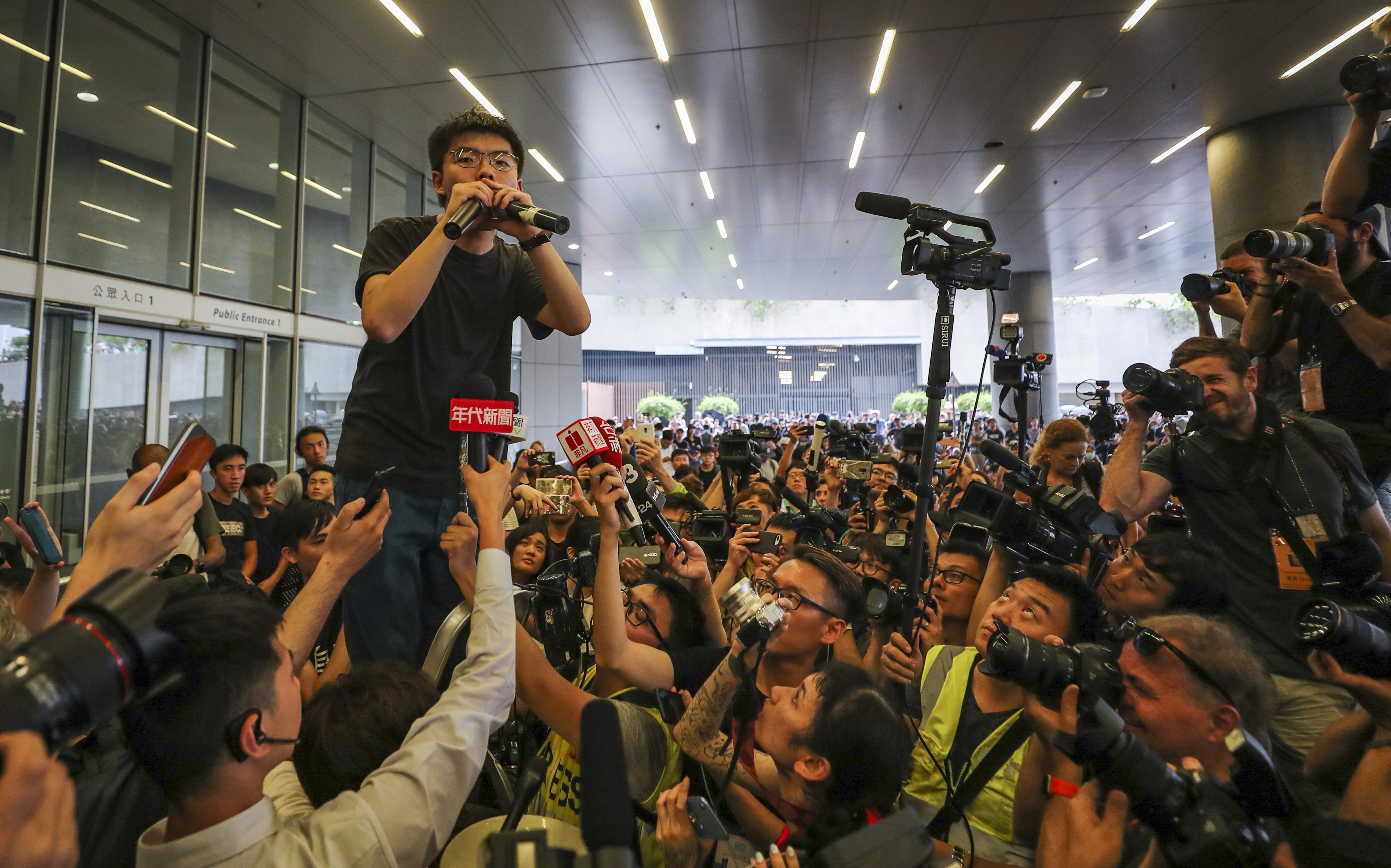 Joshua Wong is the centre of attention as he speaks to protesters against extradition law changes in Hong Kong a day after his release from prison in June. Photo: Sam Tsang
