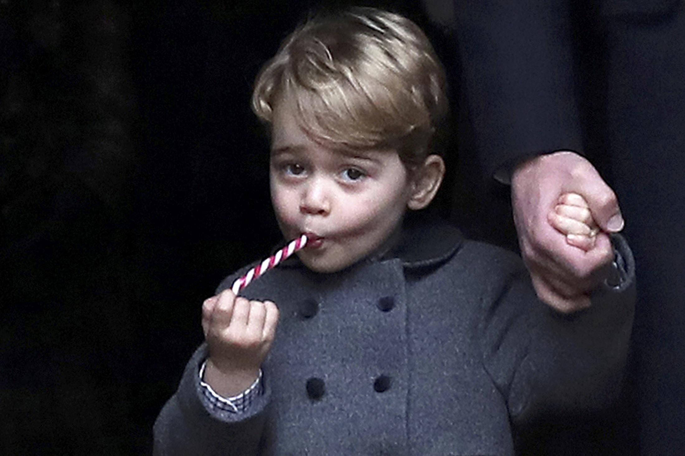 Prince George, the son of the Duke and Duchess of Cambridge, sucks a sweet following the 2016 Christmas Day service at St Mark’s Church in Englefield, near Bucklebury in southern England. Photo: Reuters