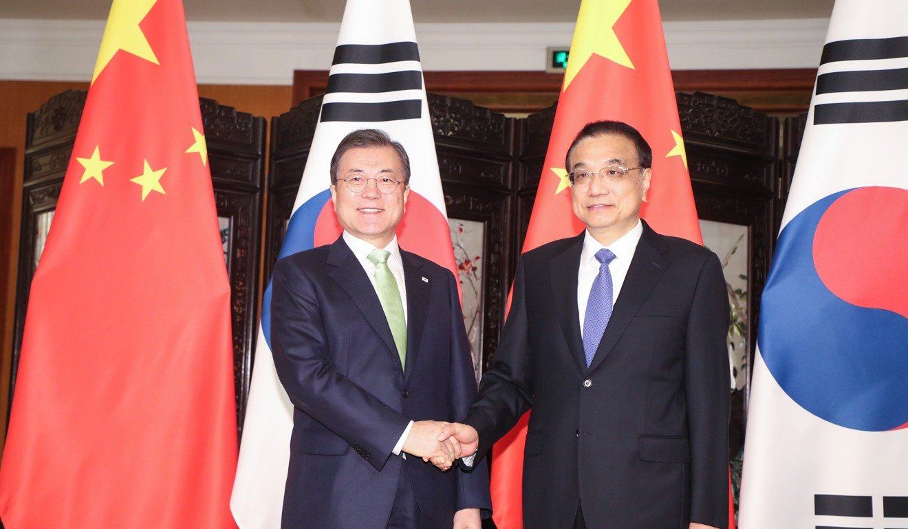 South Korean President Moon Jae-in with Chinese Premier Li Keqiang ahead of the three-way summit in Chengdu. Photo: YNA via dpa