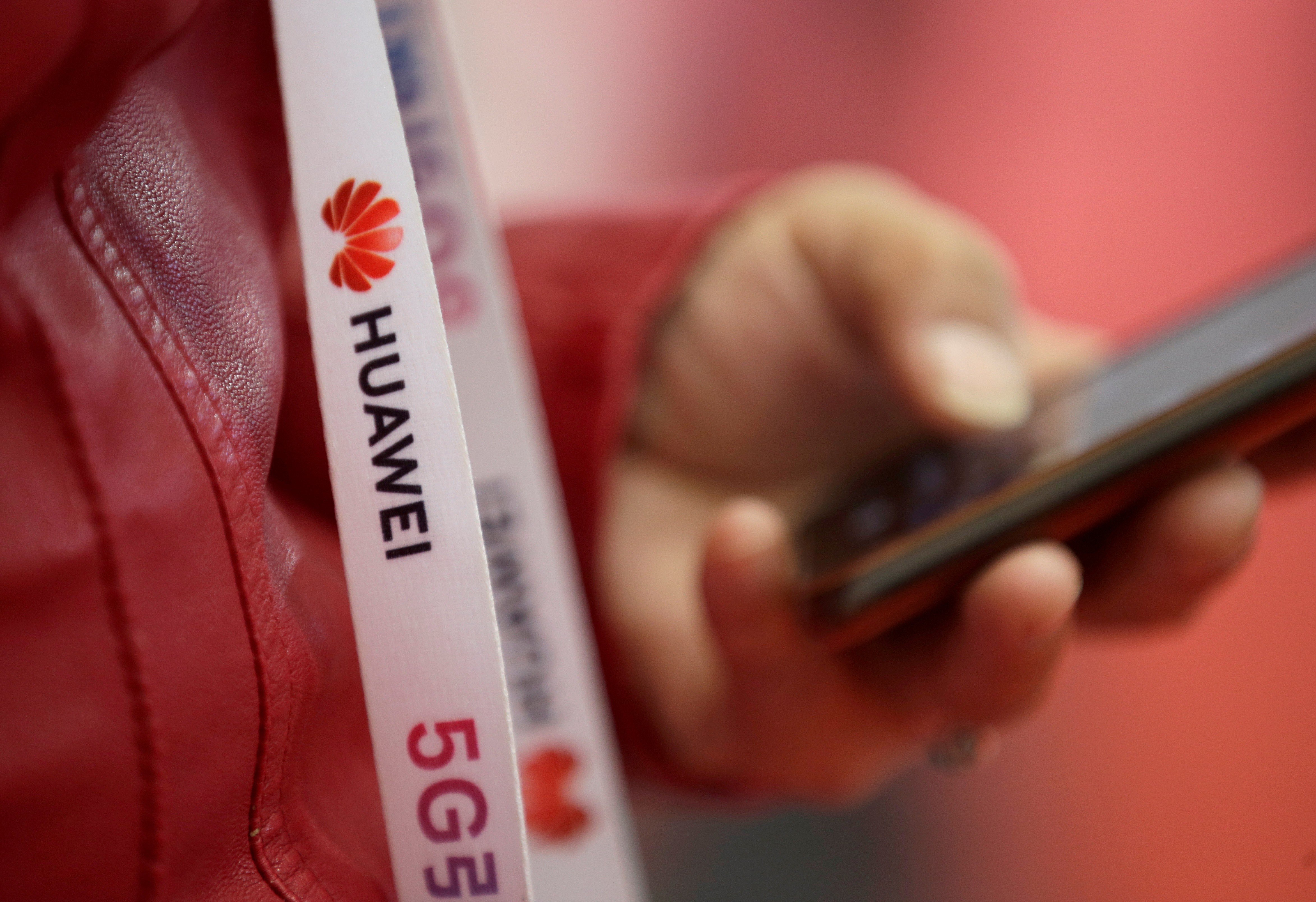 An attendee wears a badge strip with the logo of Huawei Technologies at the World 5G Exhibition in Beijing on November 22. Photo: Reuters