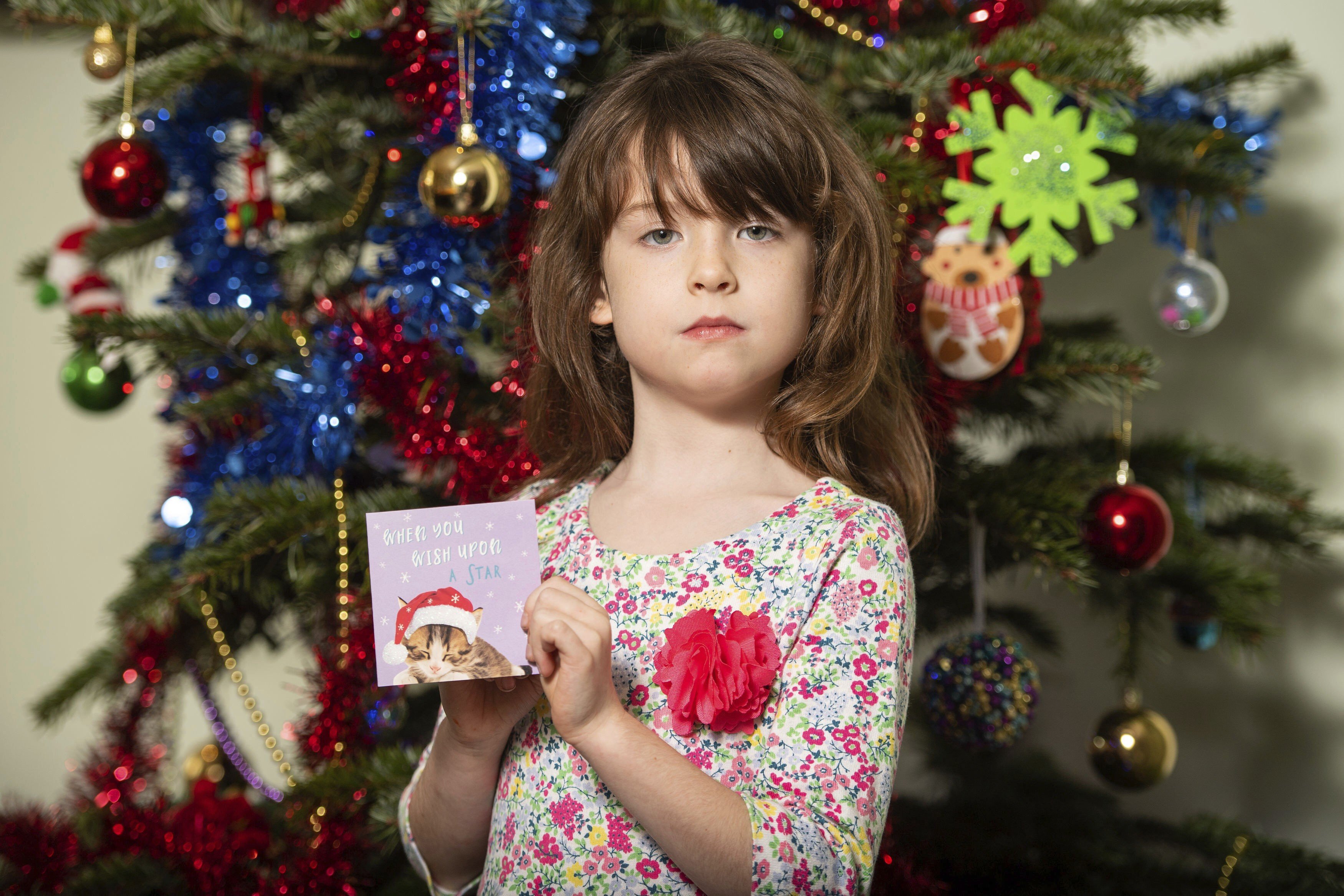 Florence Widdicombe, six, found the message in a charity card from the British retailer. Photo: PA via AP