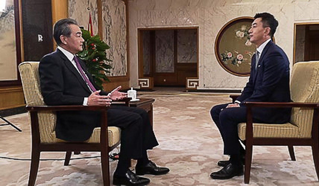 China’s Foreign Minister Wang Yi (left) during his end-of-year interview with state broadcaster CCTV. Photo: Handout