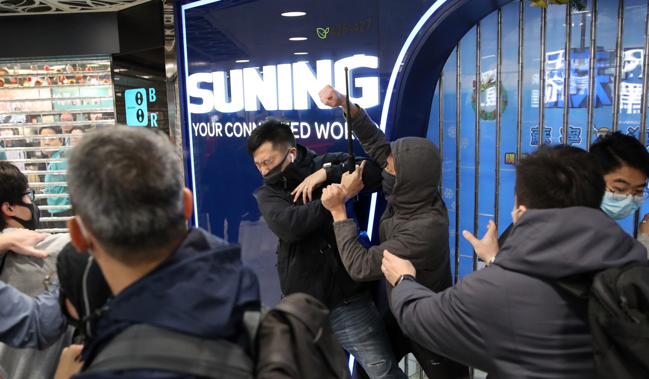 An undercover police officer and a protester clash inside the Landmark North shopping centre. Photo: Winson Wong