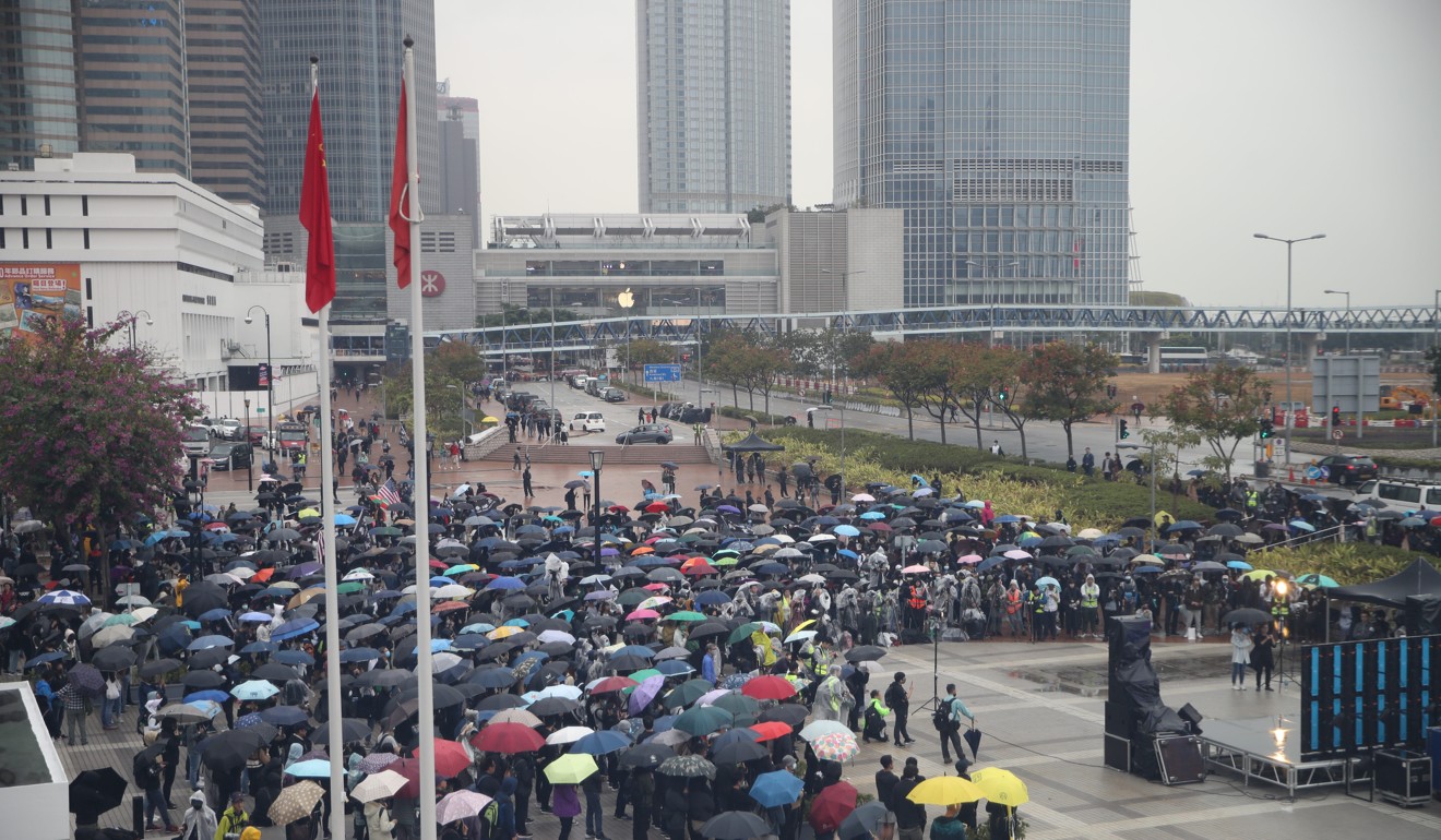 Protesters gather in the pouring rain on Sunday afternoon in Central. Photo: Winson Wong