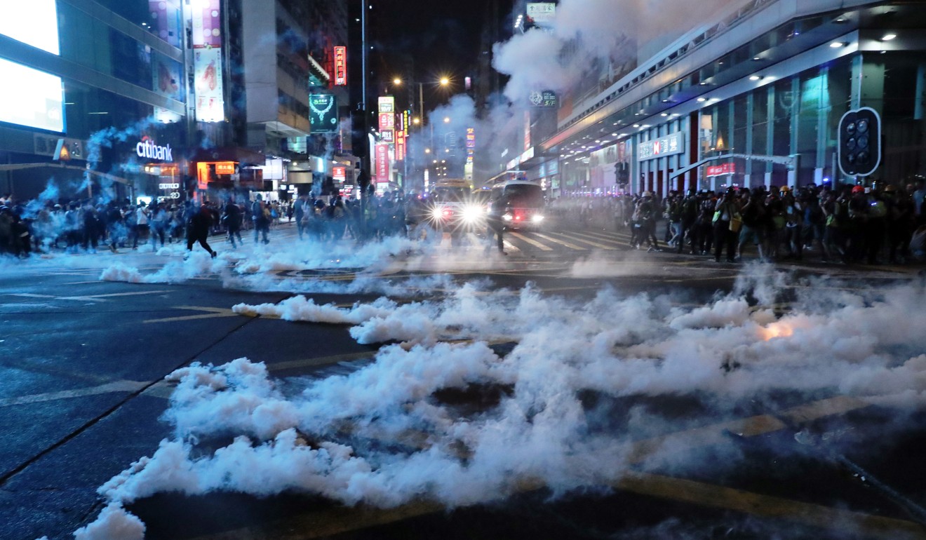 Plumes of tear gas fill a road junction in Mong Kok during a protest. Photo: Sam Tsang