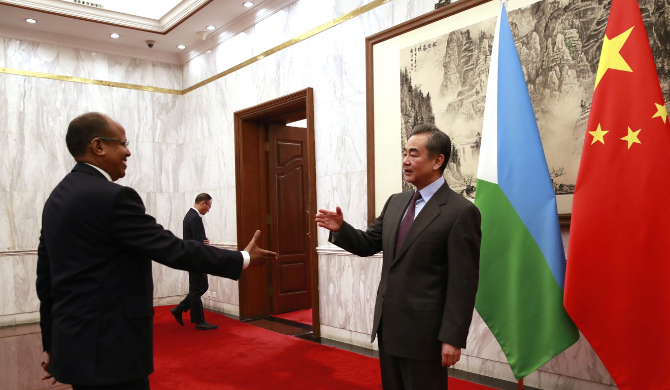 Djibouti Foreign Minister Mahamoud Ali Youssouf approaches his Chinese counterpart Wang Yi to shake hands during their meeting in Beijing earlier this year. Photo: AP