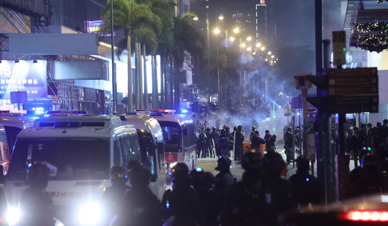 Police officers fire tear gas rounds at Tsim Sha Tsui as Christmas Eve protests break out in Hong Kong. Photo: May Tse