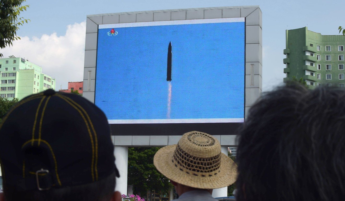 Pyongyang residents watch the successful launch of an ICBM in 2017. Photo: AFP