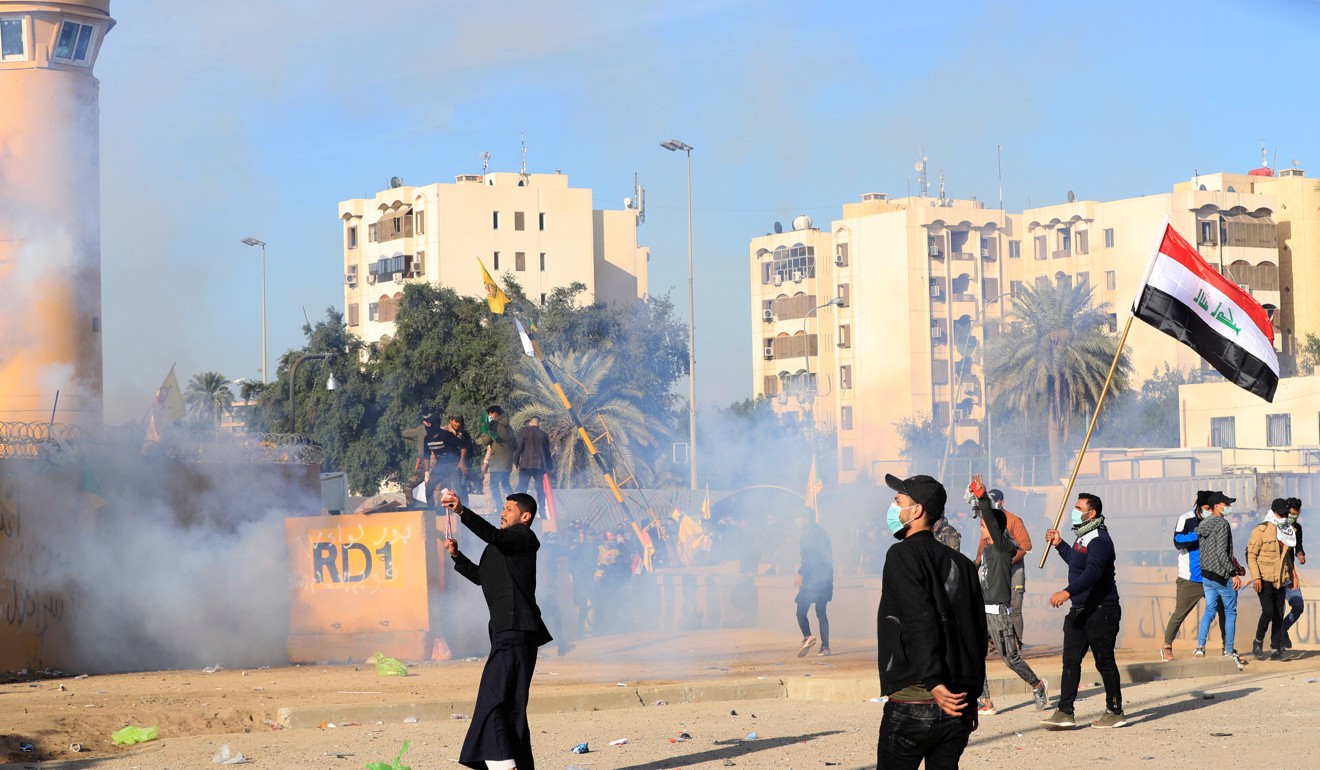 US embassy guards use tear gas to disperse protesters in Baghdad. Photo: Reuters