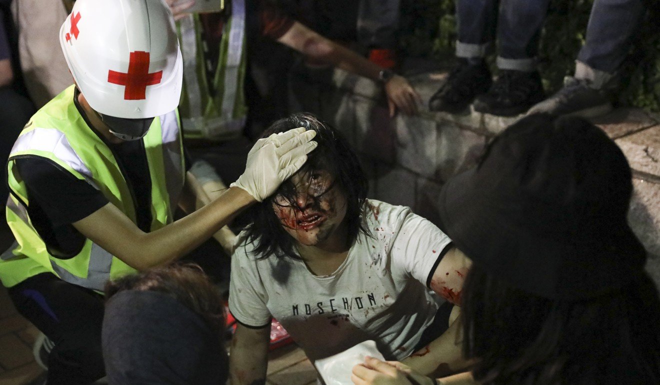 A first-aider treats one of the injured during a protest. Photo: K.Y. Cheng