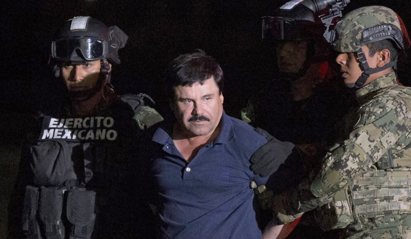 Mexican drug lord Joaquin ‘El Chapo’ Guzman is escorted by army soldiers in Mexico City, after he was recaptured from breaking out of a maximum security prison. Photo: AP