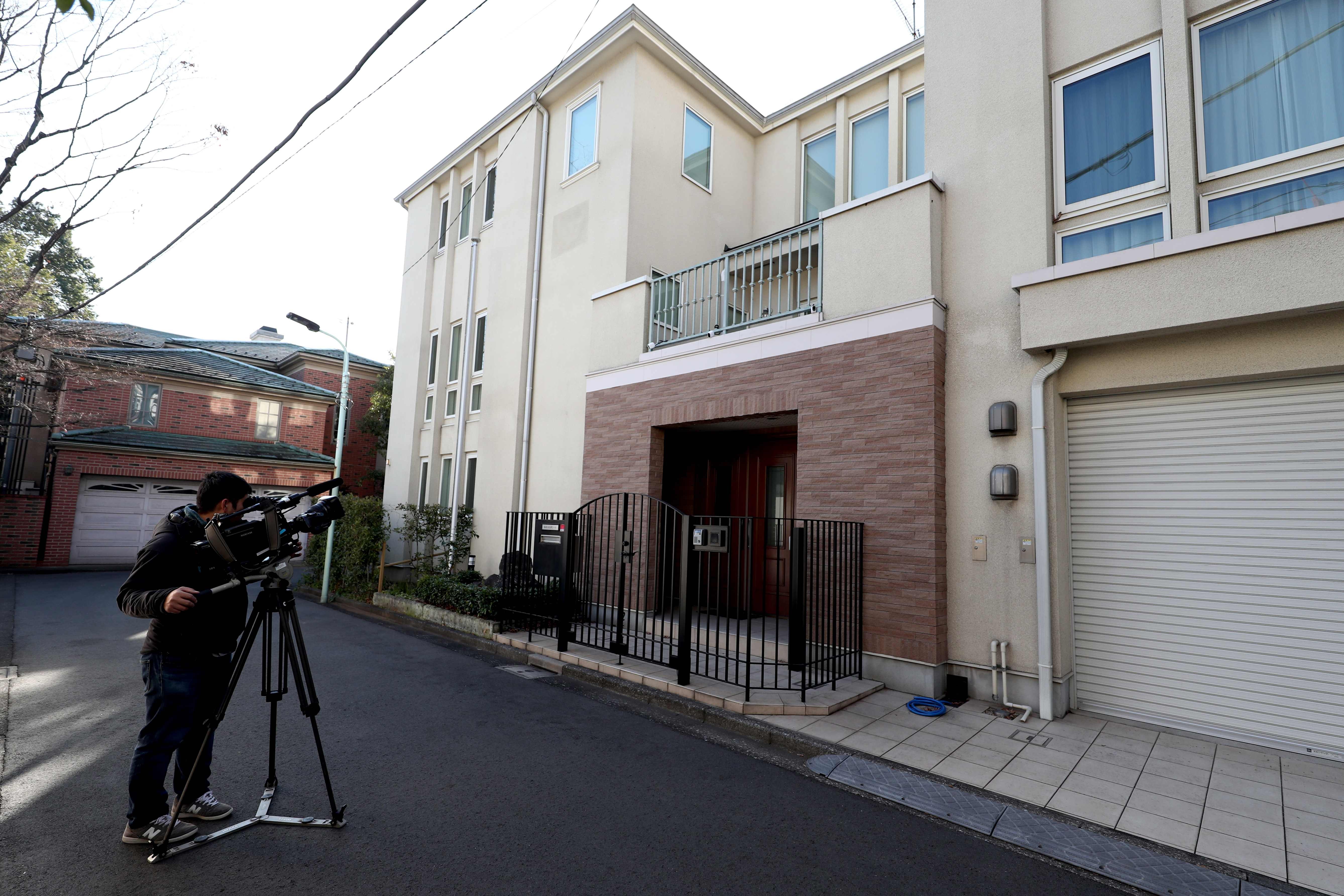 A cameraman films the residence of former Nissan chairman Carlos Ghosn in Tokyo on January 3, after Ghosn fled Japan to avoid a trial. Photo: AFP