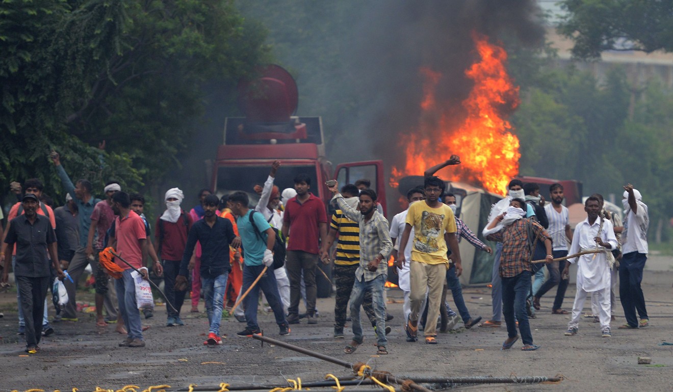 Supporters of Indian religious leader Gurmeet Ram Rahim riot after he was sent to prison in 2017. Photo: AFP