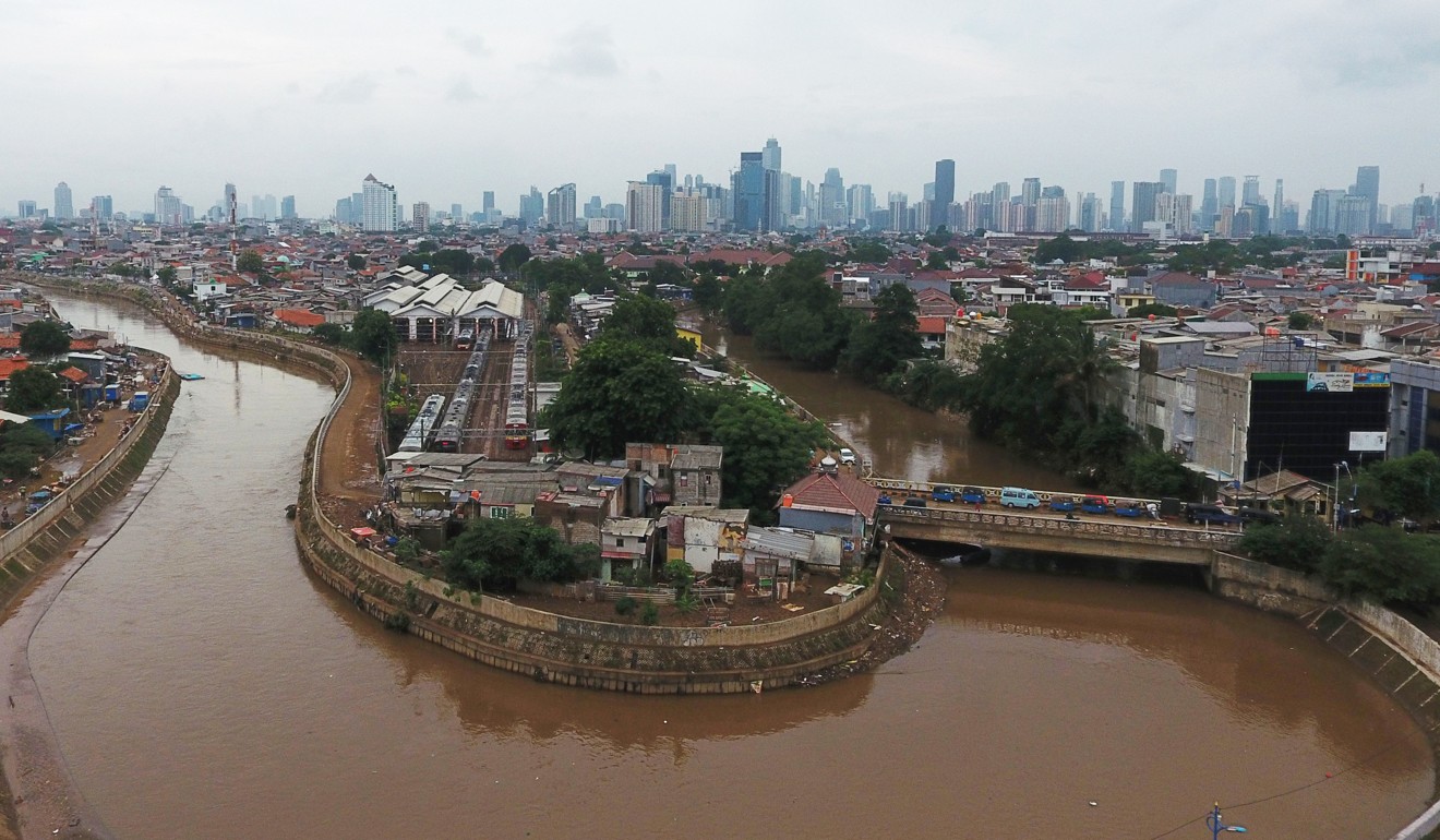 Houses stand along Ciliwung River in the Jatinegara district of Jakarta. Photo: Bloomberg